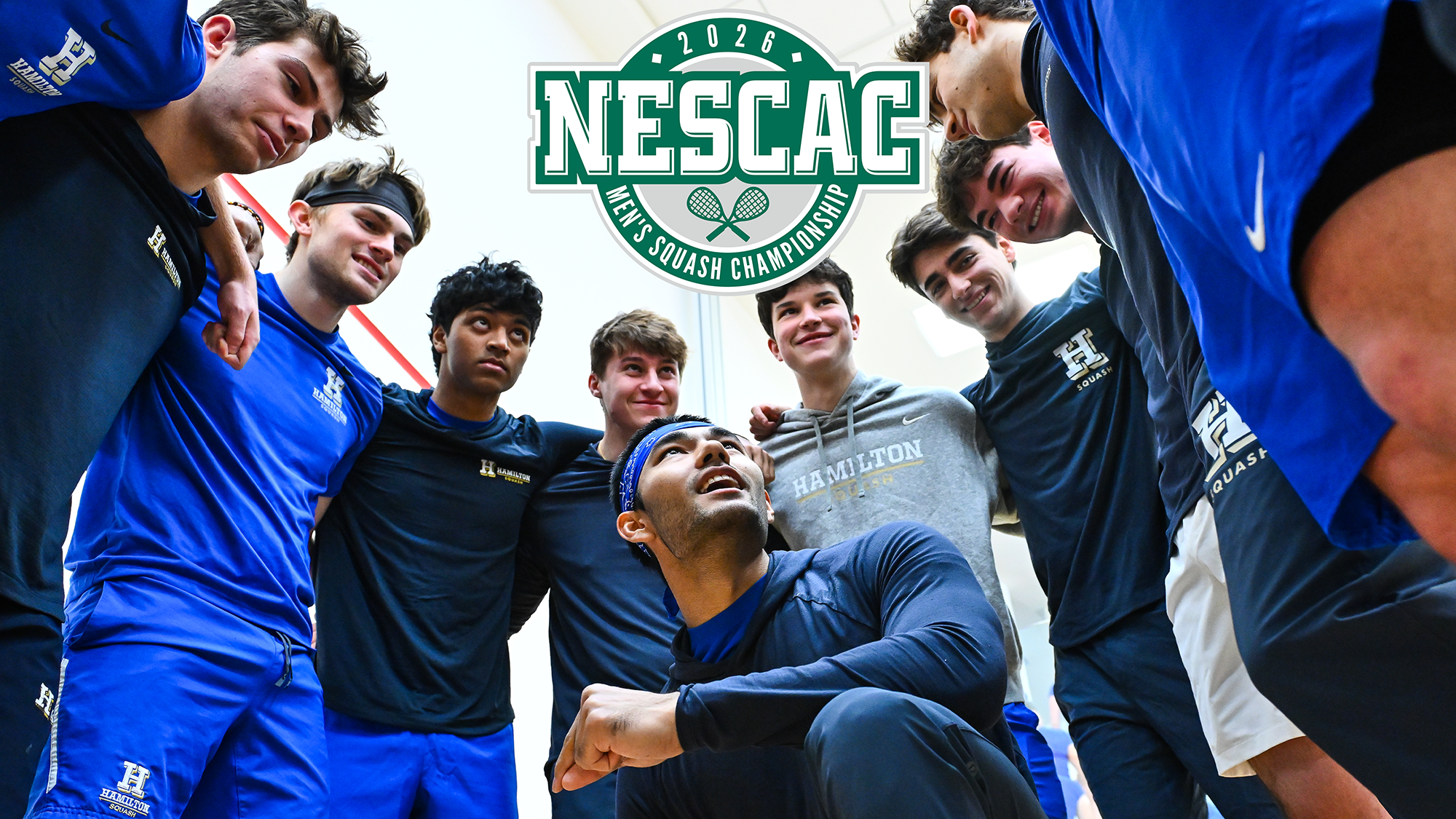 Atreyus Bhavsar glances upwards as the Men's Squash team huddles around him before the Denison match