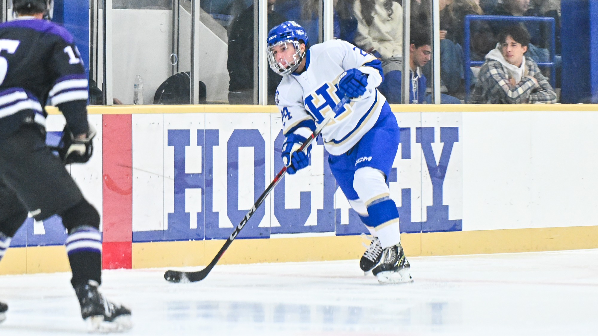 Liam Varmecky dumps the puck into the offensive zone from the red line against Amherst