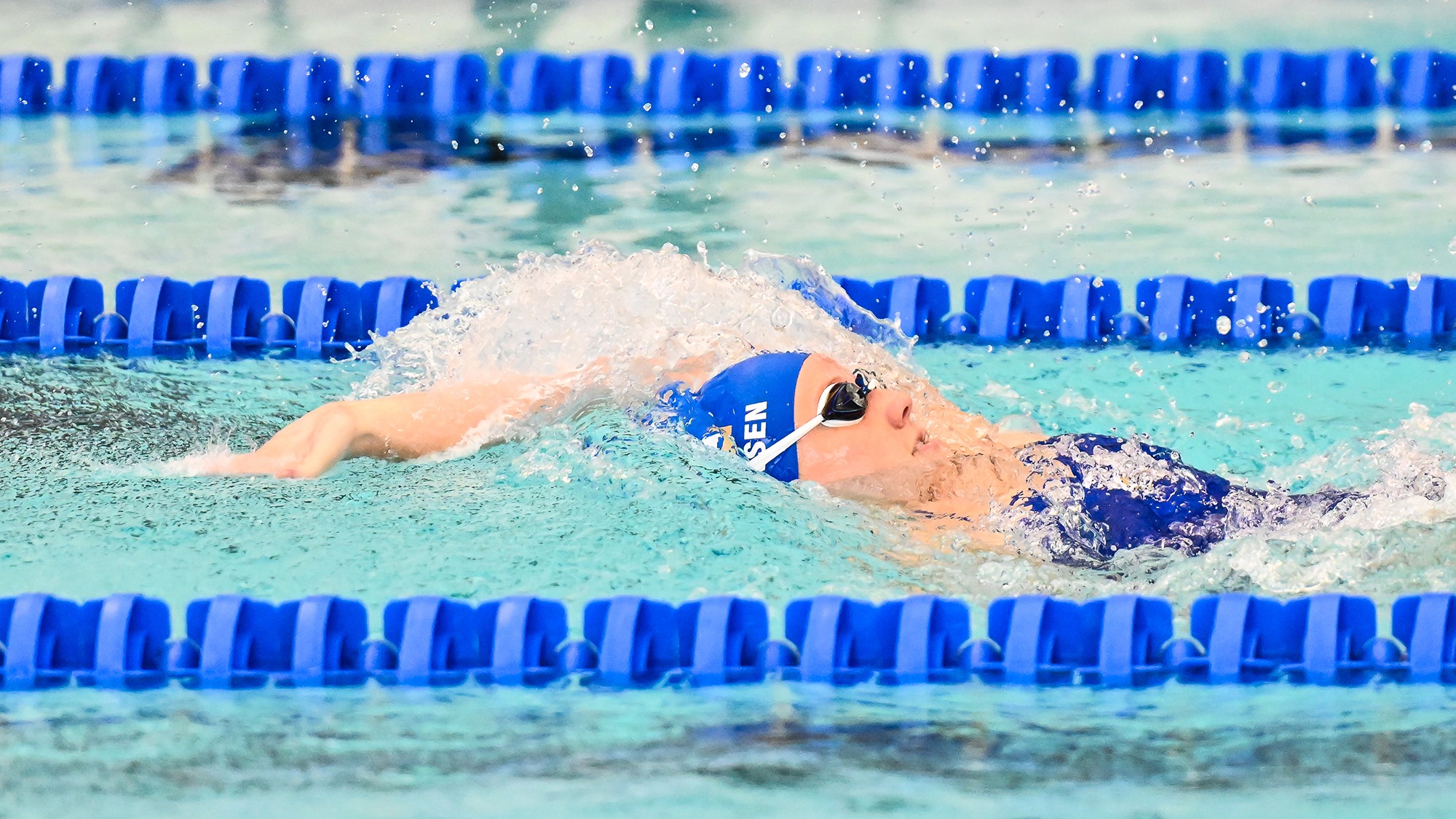 Charlotte Sorensen swims the backstroke in the RIT dual meet