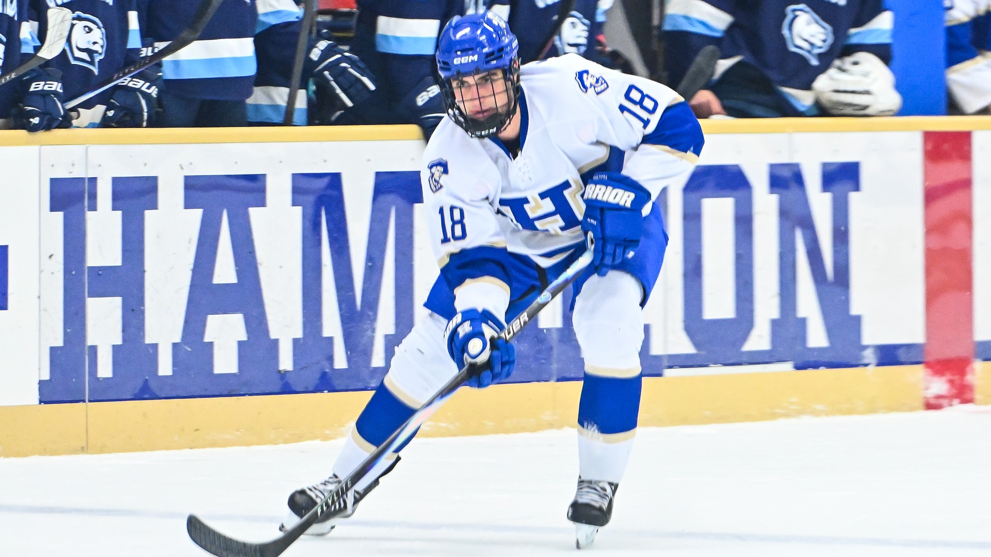 Max Bulawka looks up with the puck on his stick in the attacking zone against Connecticut College