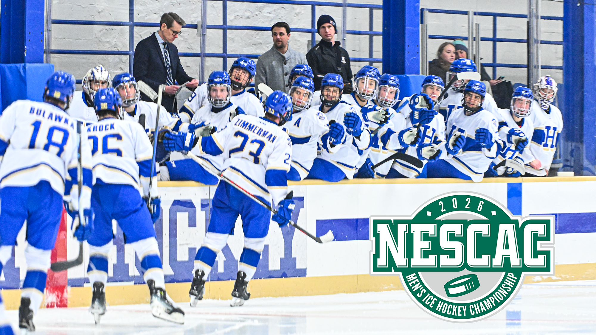 Men's Hockey players are congratulated as they skate by the team bench after scoring a goal