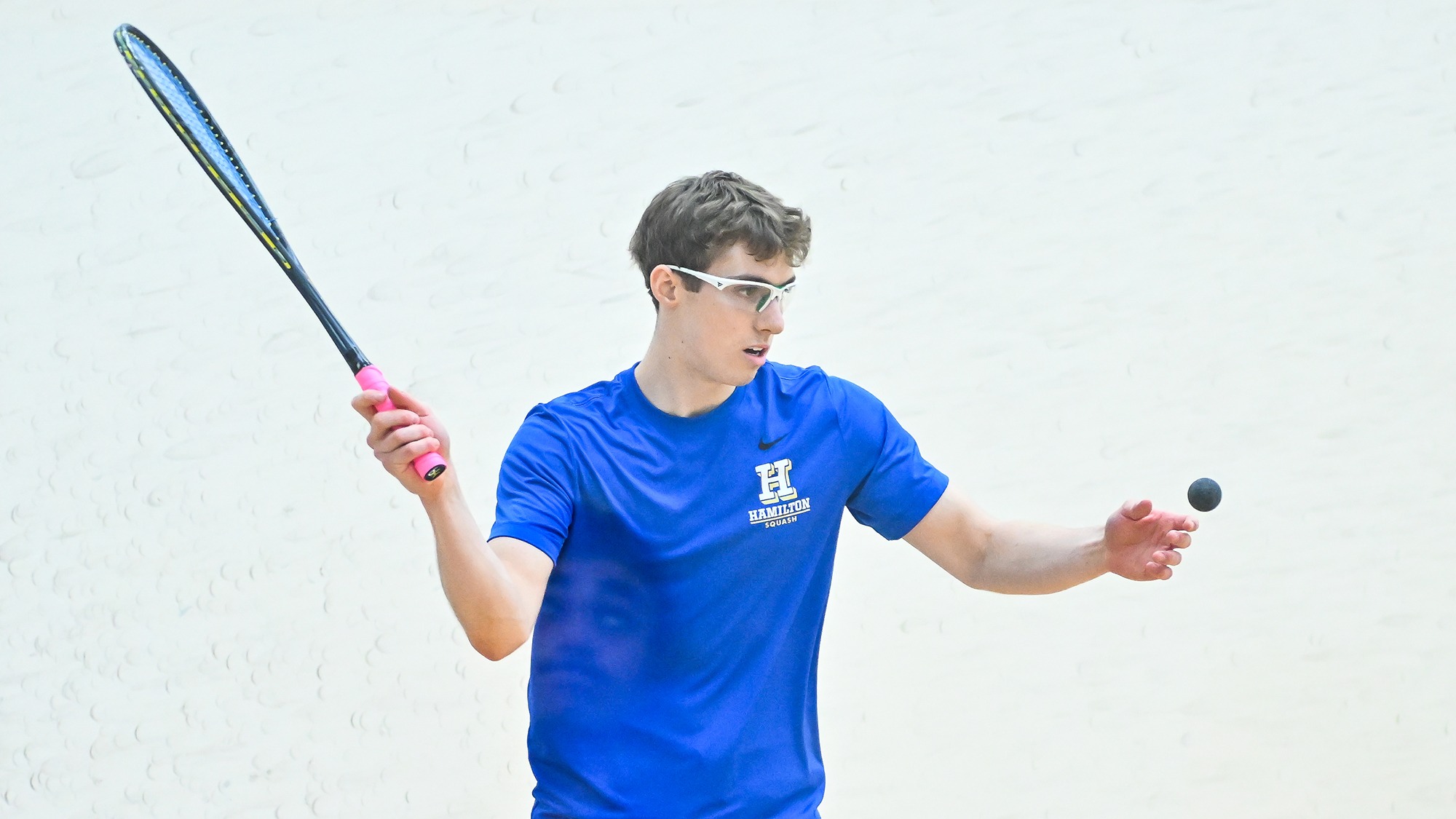 Joseph Applebaum serves the squash ball against Denison