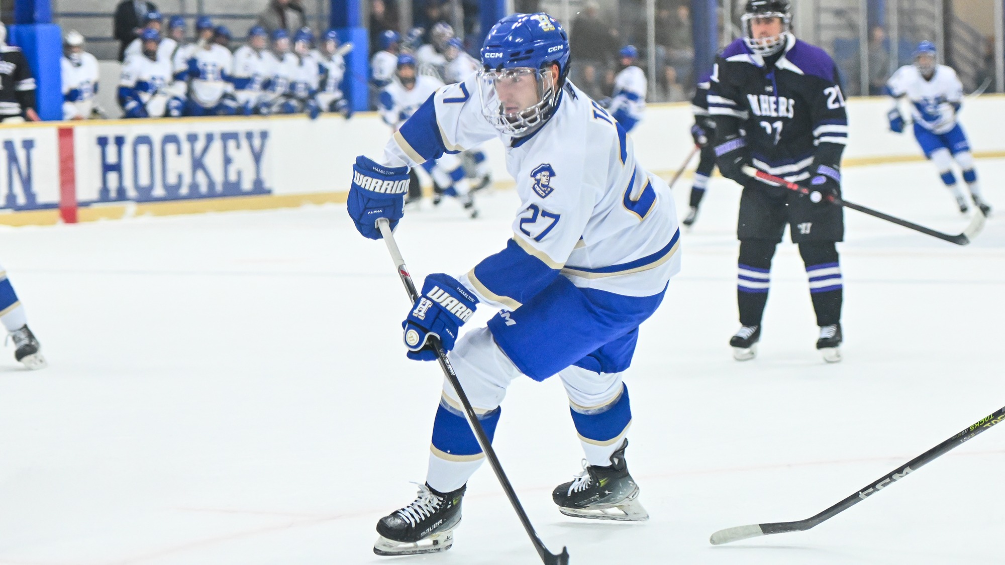 Luke Tchor has the hockey puck on his stick and is eyeing the goal against Amherst