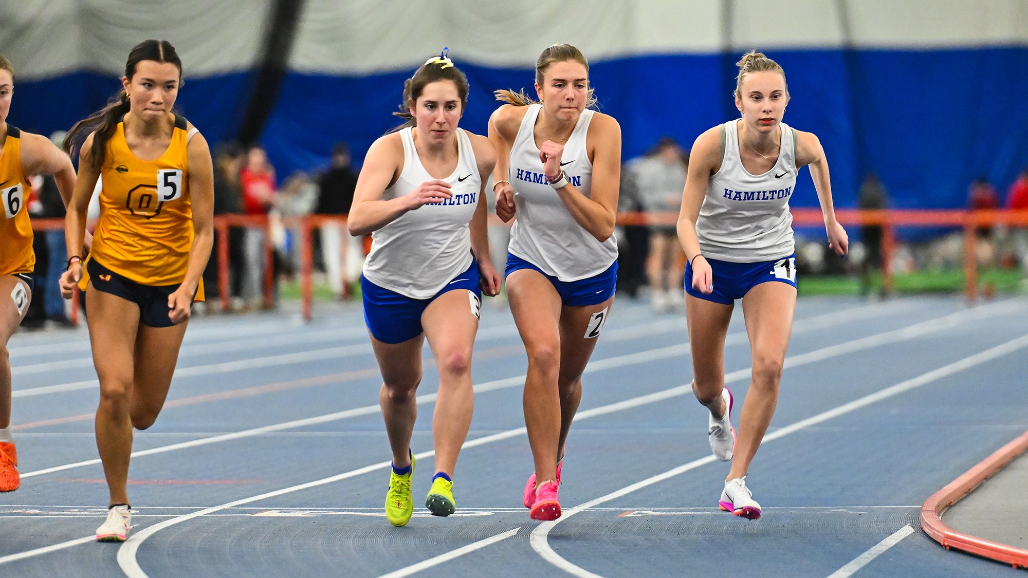 Women's track and field athletes start running in the 800 meters at Utica University