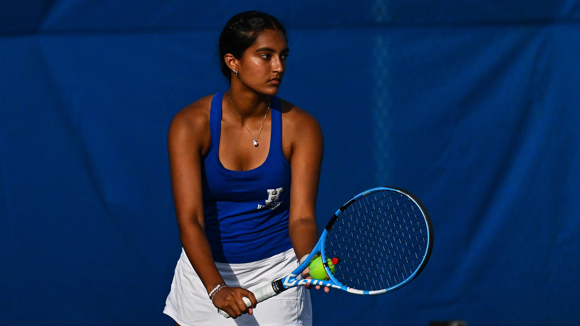 Priyanka Challapalli prepares to serve during women's tennis practice in September 2025