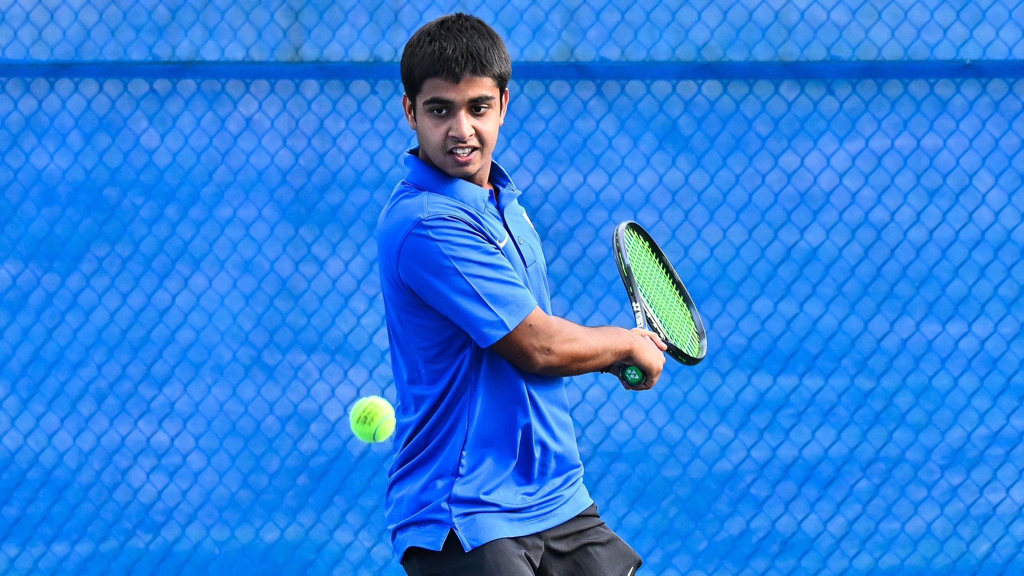 Akshat Dhull prepares to hit a backhand return during men's tennis practice in September 2025 