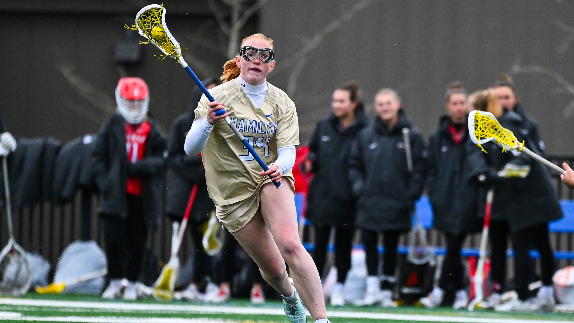 Elizabeth Rudge looks for a teammate to pass to against Wesleyan in 2025