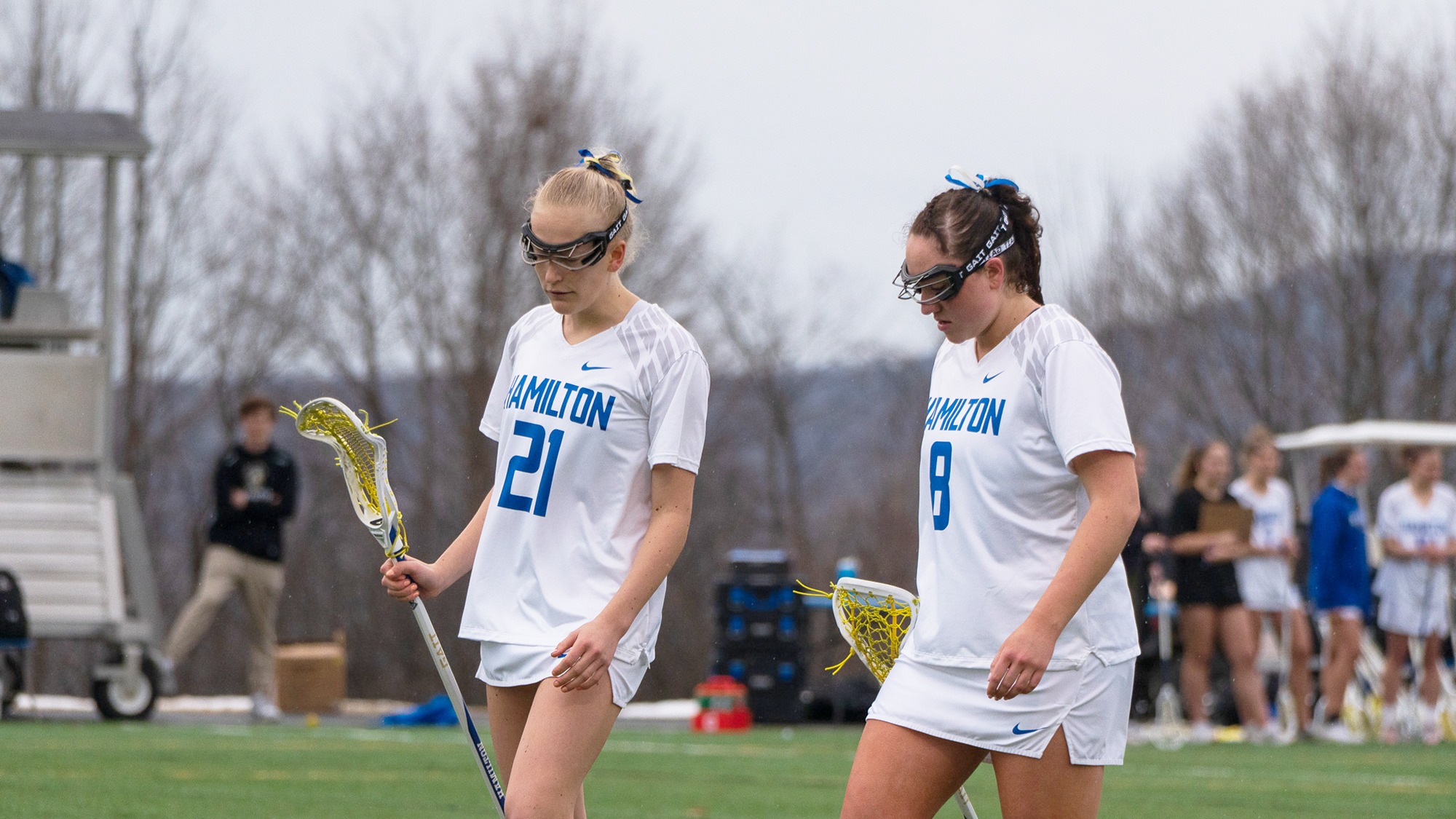 Women's lacrosse players Grace MacLean and Sophia Wright discuss strategy while waiting for the draw control