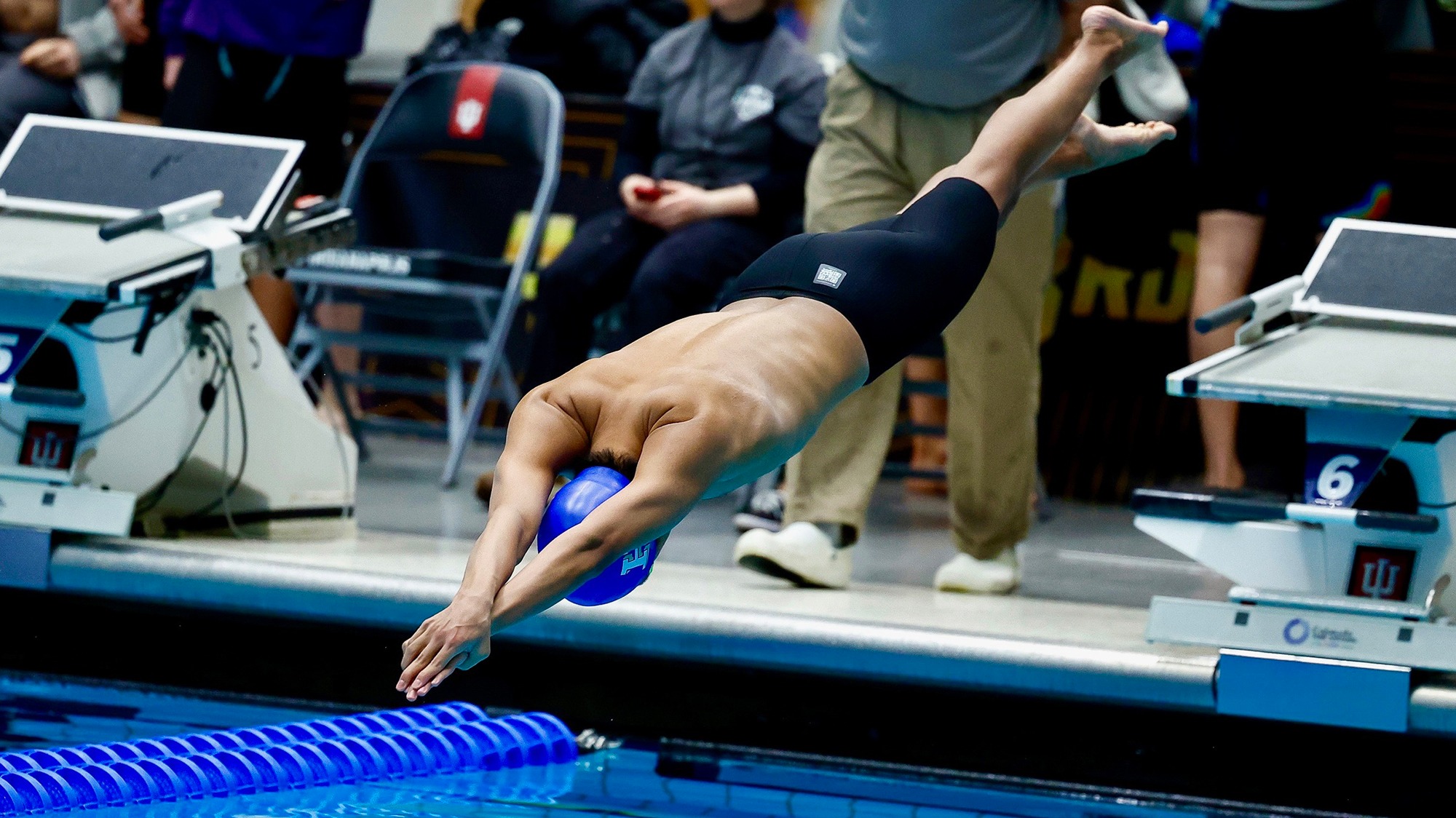 Matthew Chang jumps off the starting block at the start of the 100 fly during the 2026 NCAA Swimming and Diving Championships