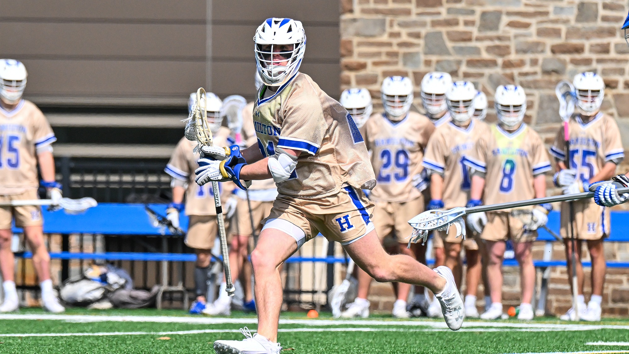 Carson Kraus looks to pass the ball in a men's lacrosse game against Colby
