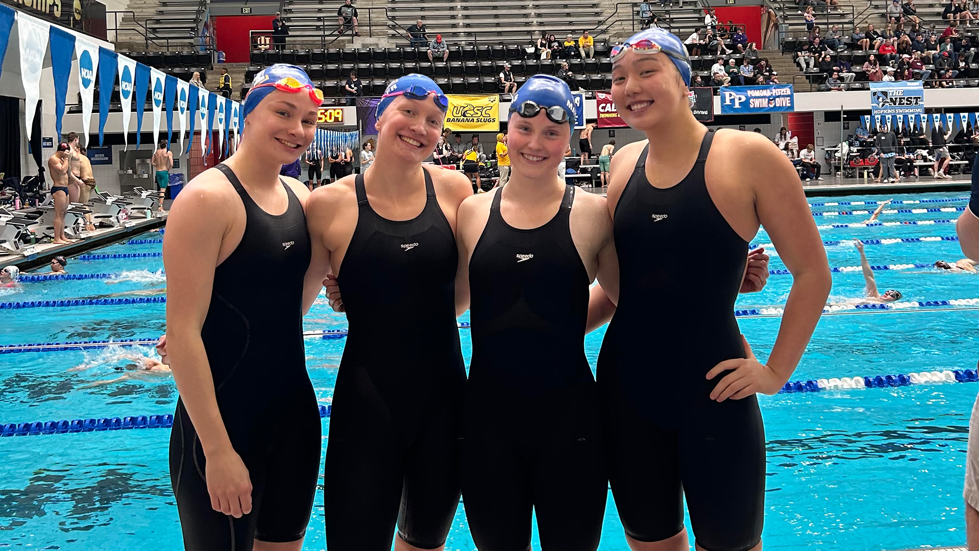 Four members of the Women's Swimming and Diving team pose after competing in the NCAA championships on March 19