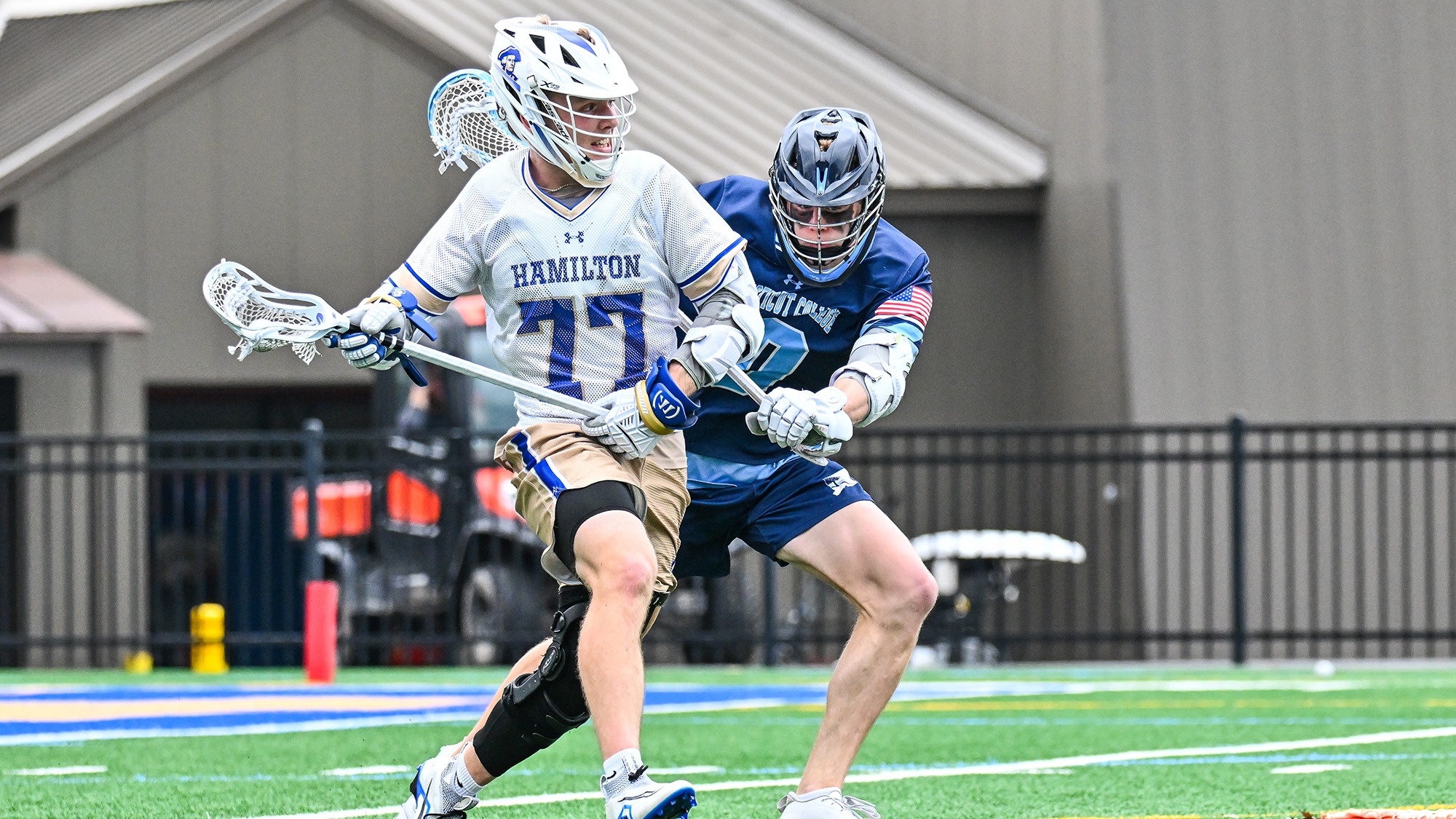 Frank Coyle absorbs a check from a Connecticut College defender in April 2025