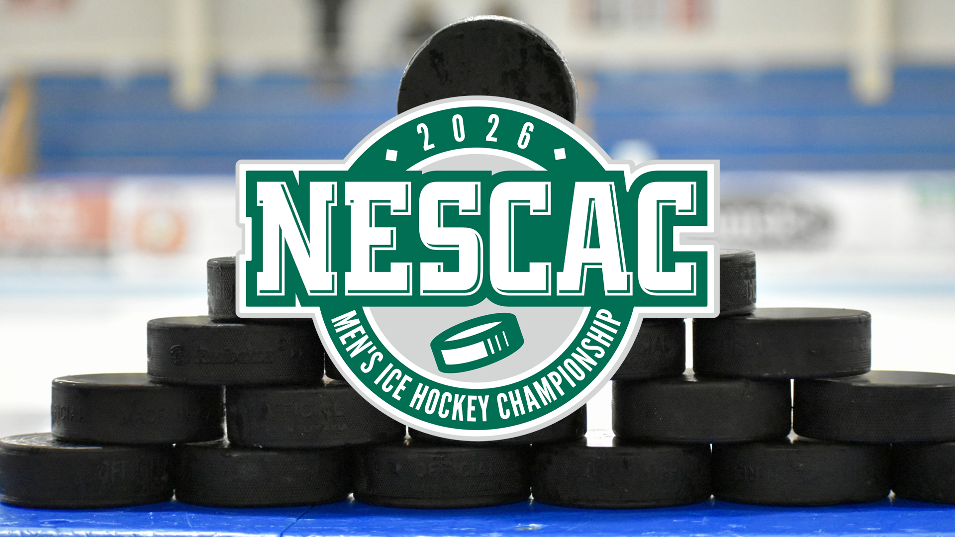 Hockey pucks stacked on top of the boards prior to warmups with the NESCAC Championship logo