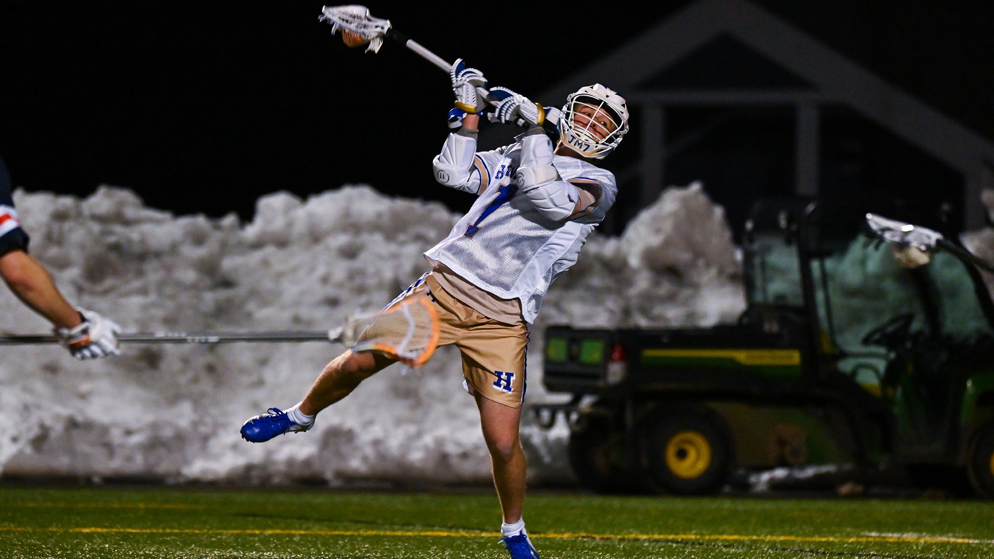 Maddux Little winds up for a shot in a men's lacrosse game against Utica