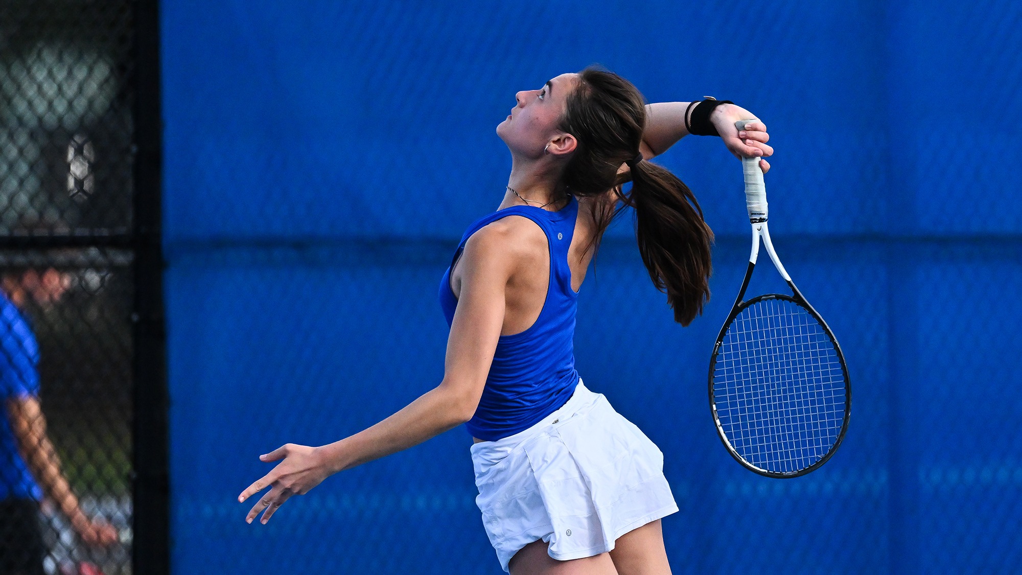 Lila Freeman serves during women's tennis practice in fall 2025