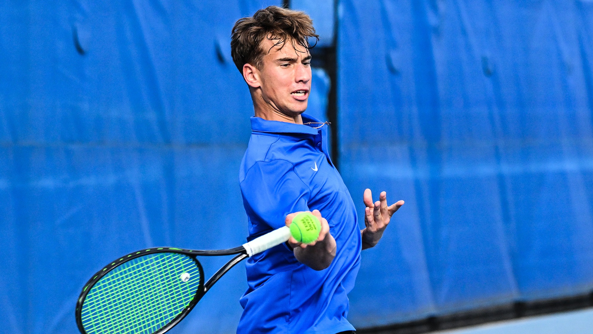 Alexei Katelevsky hits a forehand return during men's tennis practice in September 2025