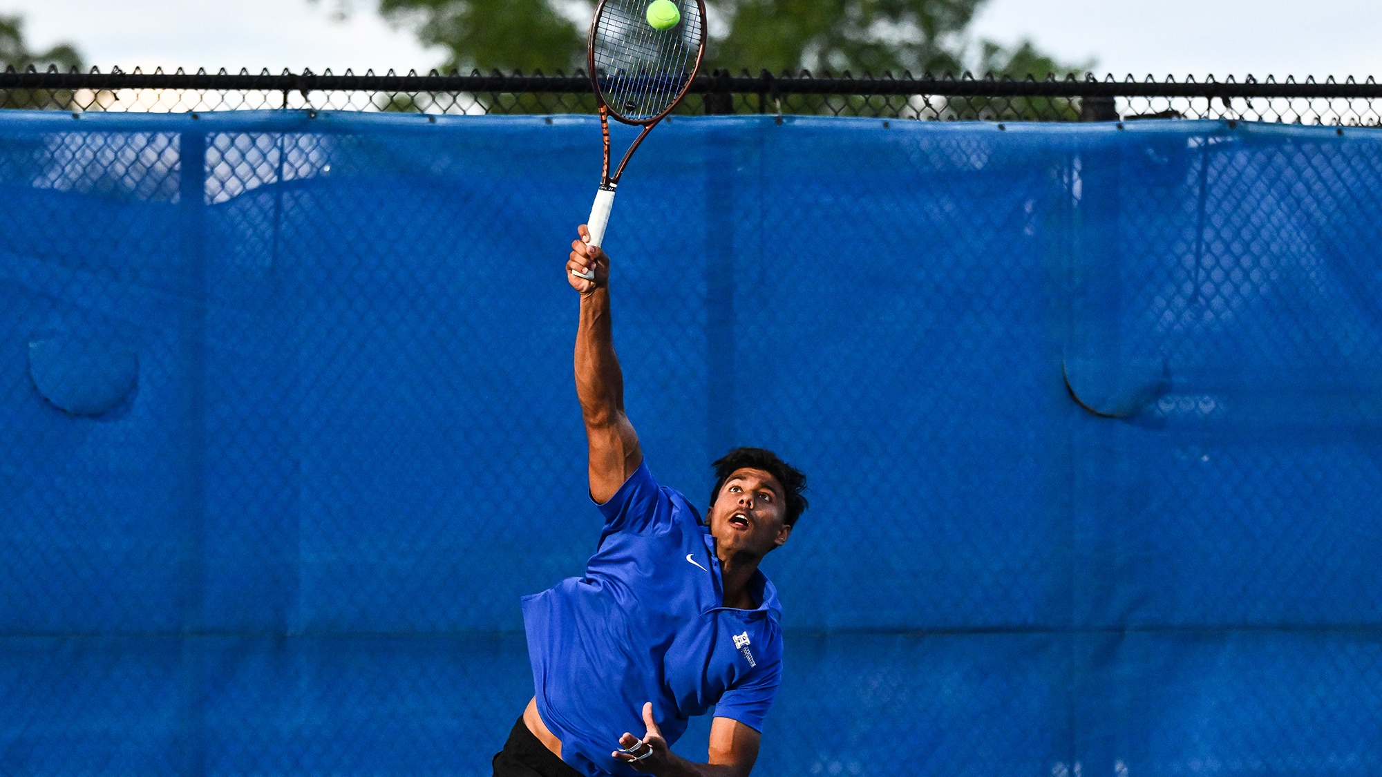 Tarun Korwar serves during tennis practice in September 2025