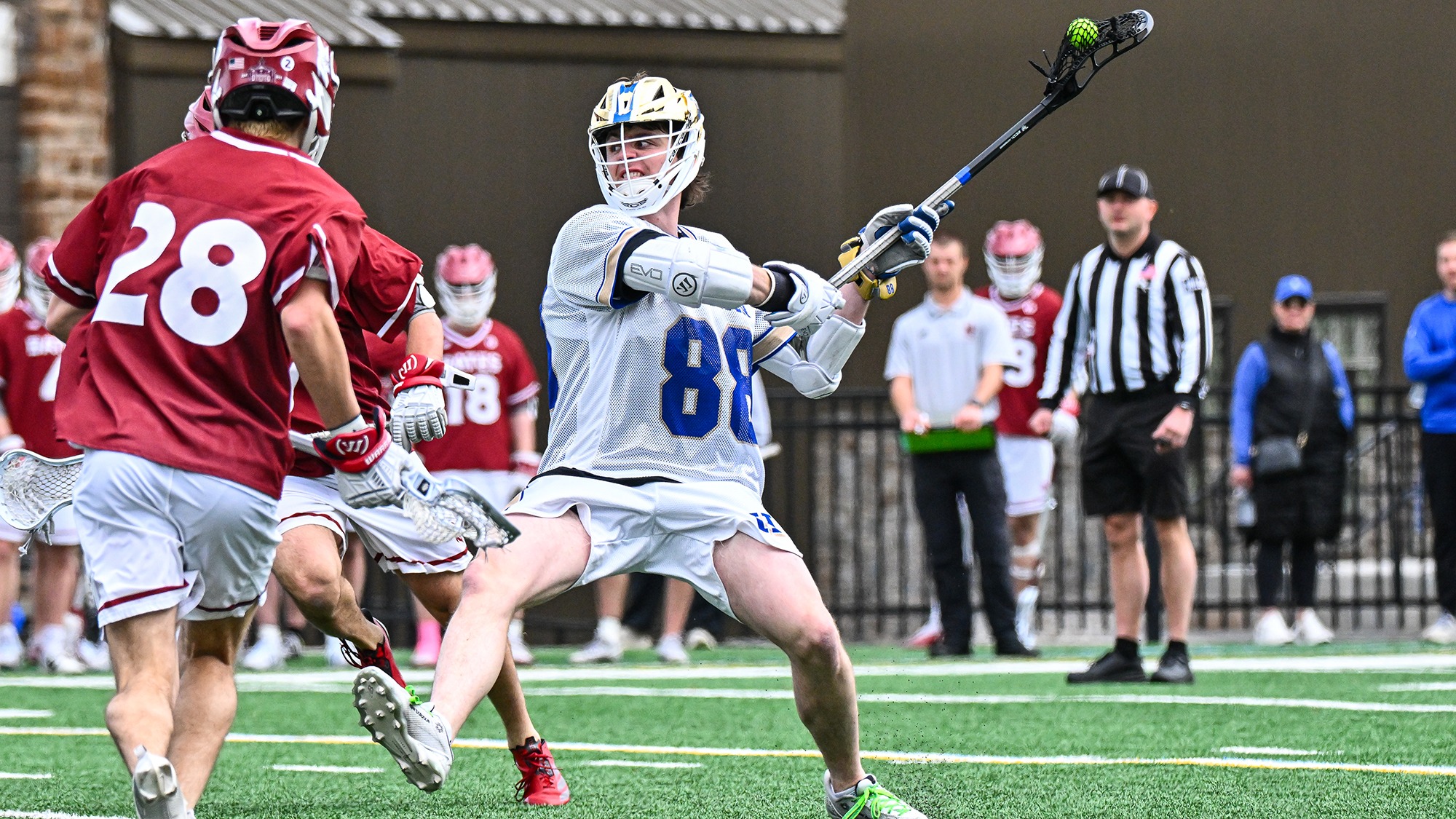 Thomas Healy takes a shot in a men's lacrosse game against Bates