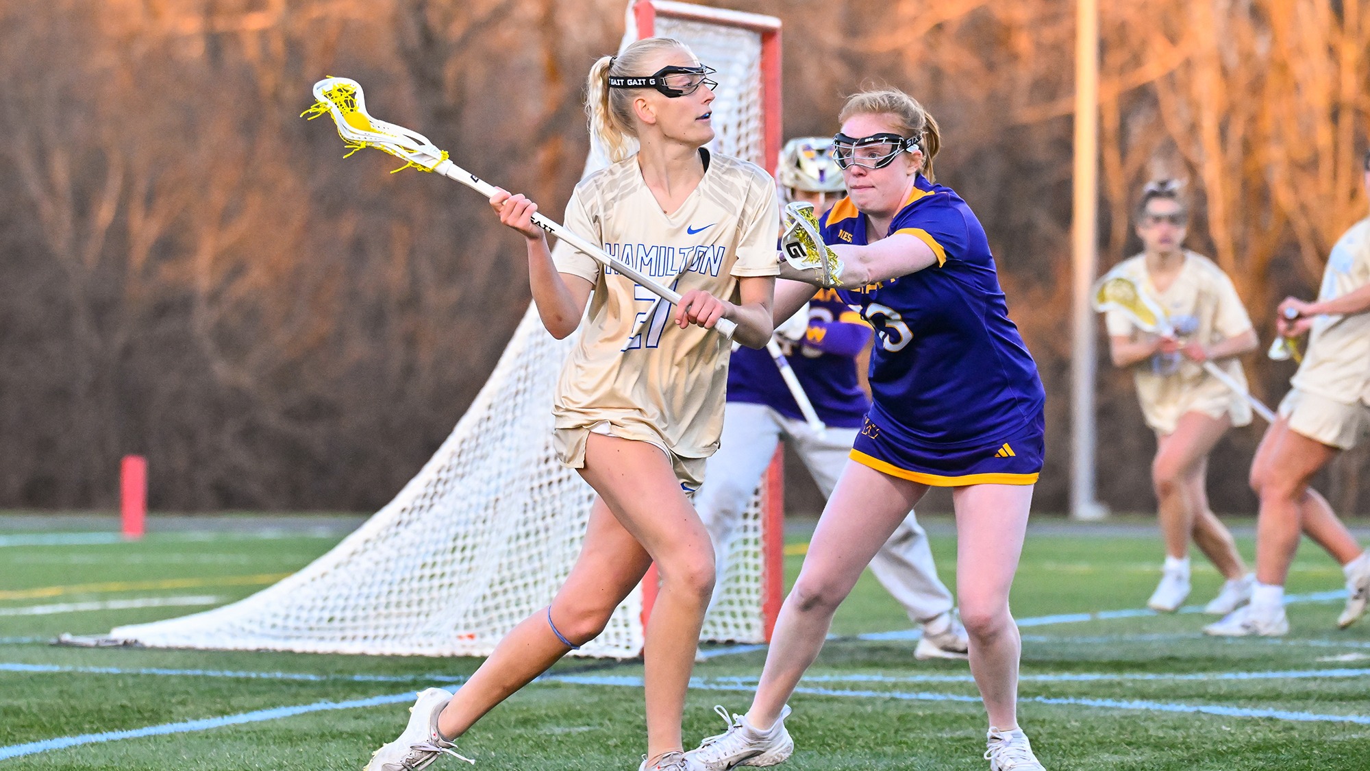 Grace MacLean looks to pass as she moves around the left side of the goal in a women's lacrosse game against Williams