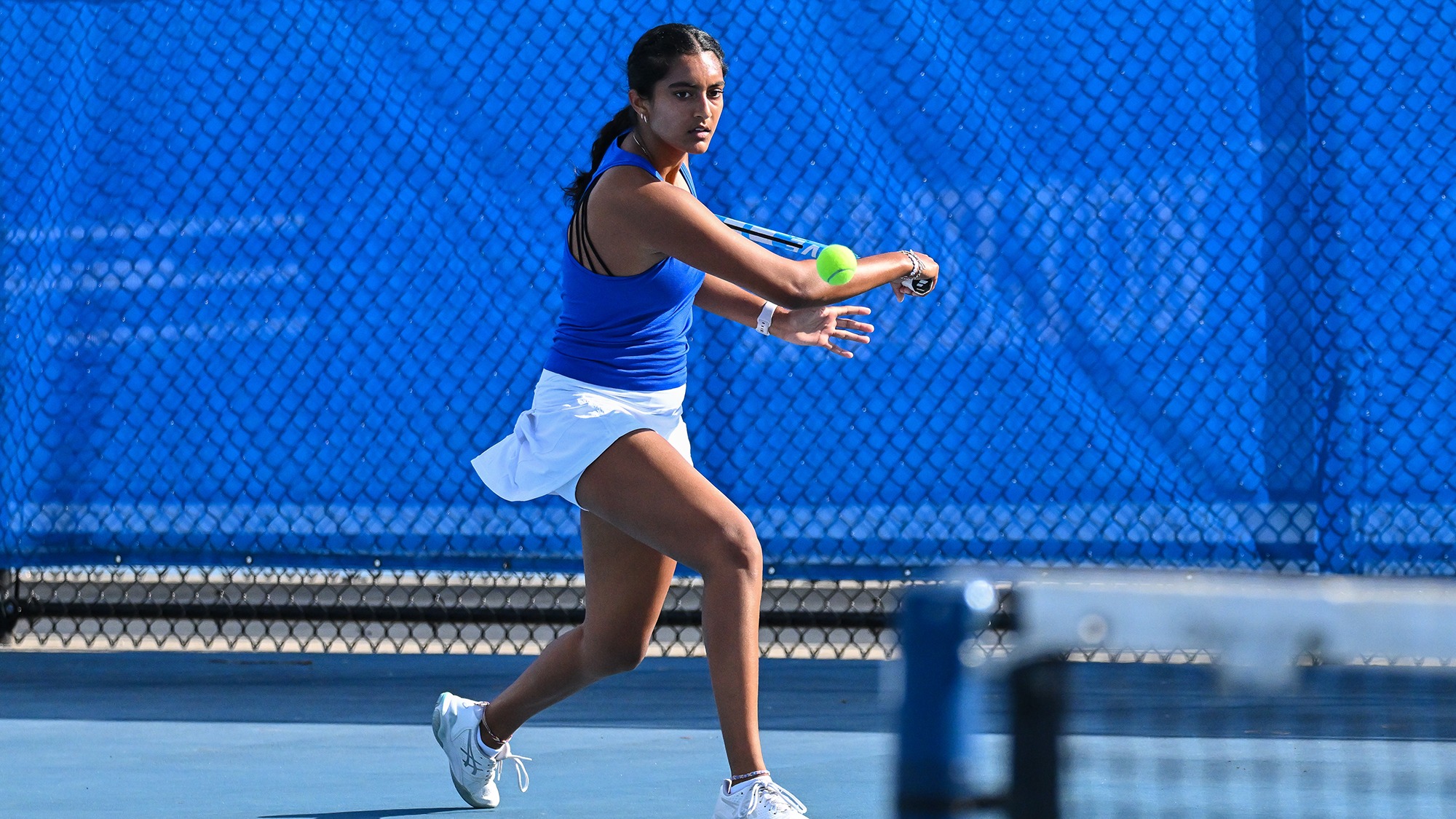 Priyanka Challapalli hits a backhand return during women's tennis practice in September 2025