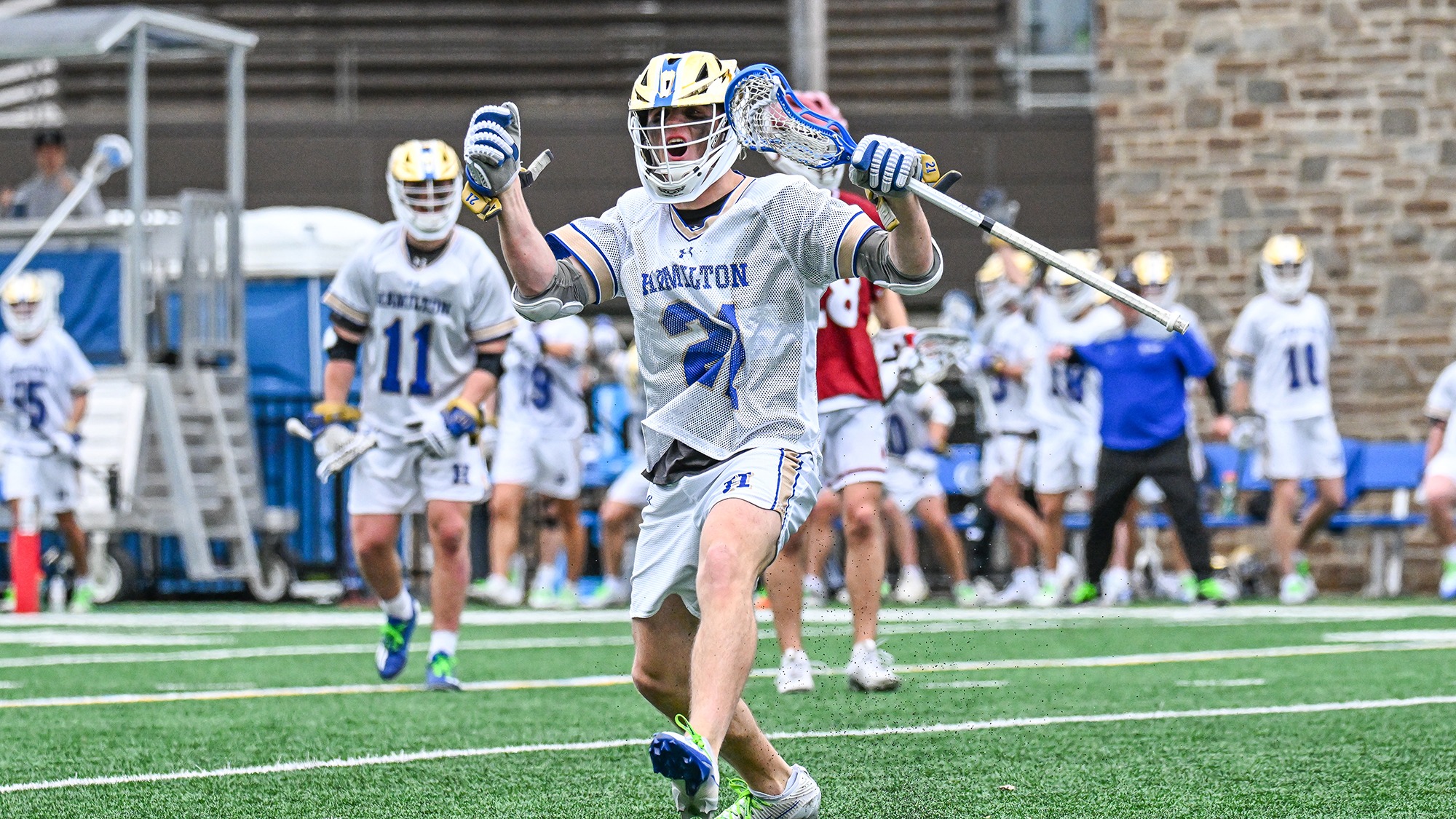 Carson Kraus celebrates a goal in a men's lacrosse game against Bates