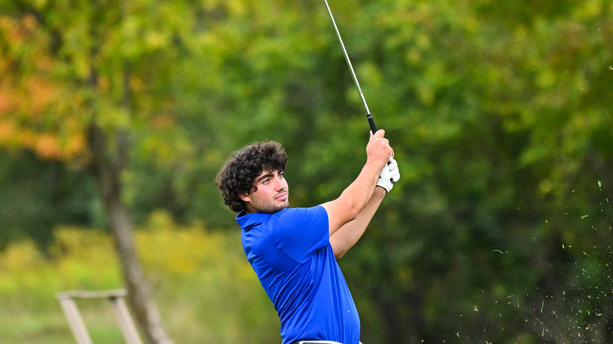 Ramon Aroca Gonzalez watches his iron shot on the driving range during men's golf practice in September 2025