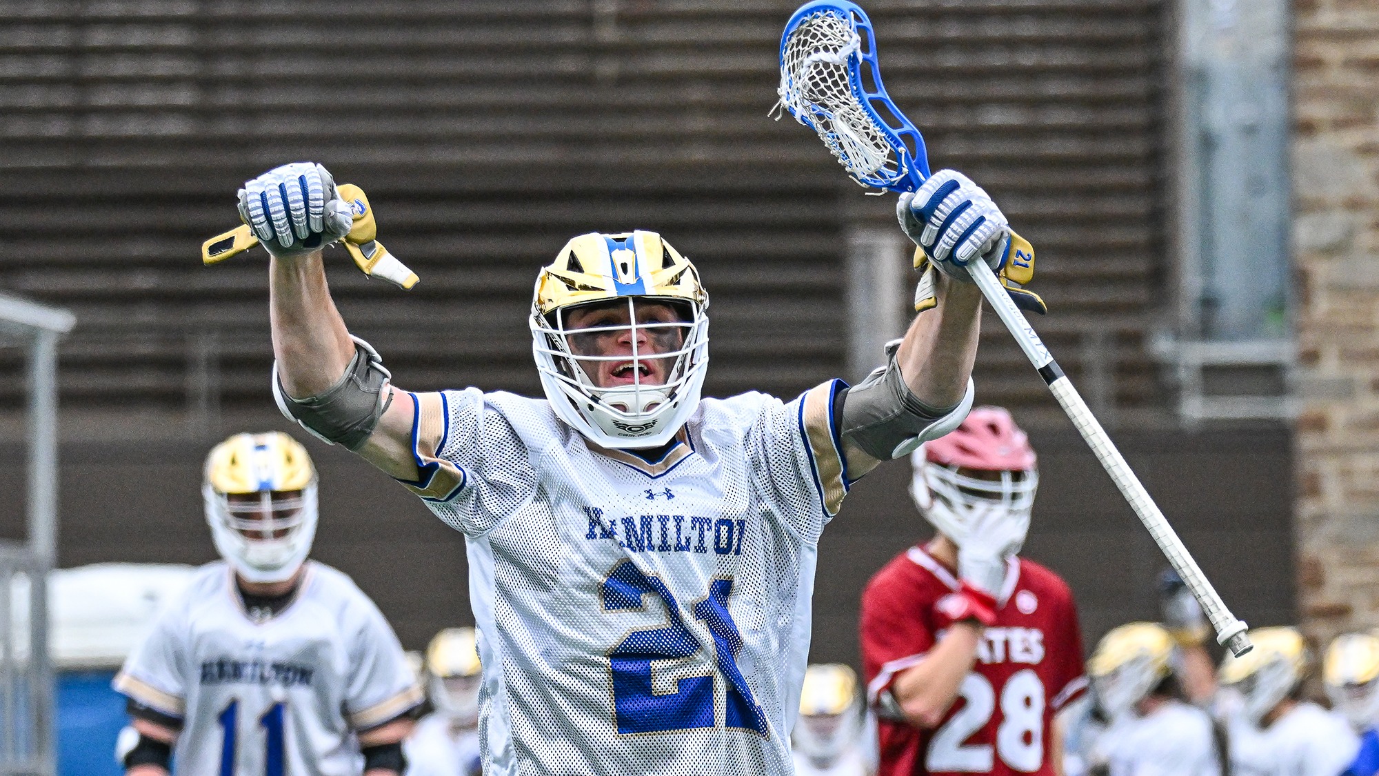 Carson Kraus celebrates a goal in a men's lacrosse game against Bates