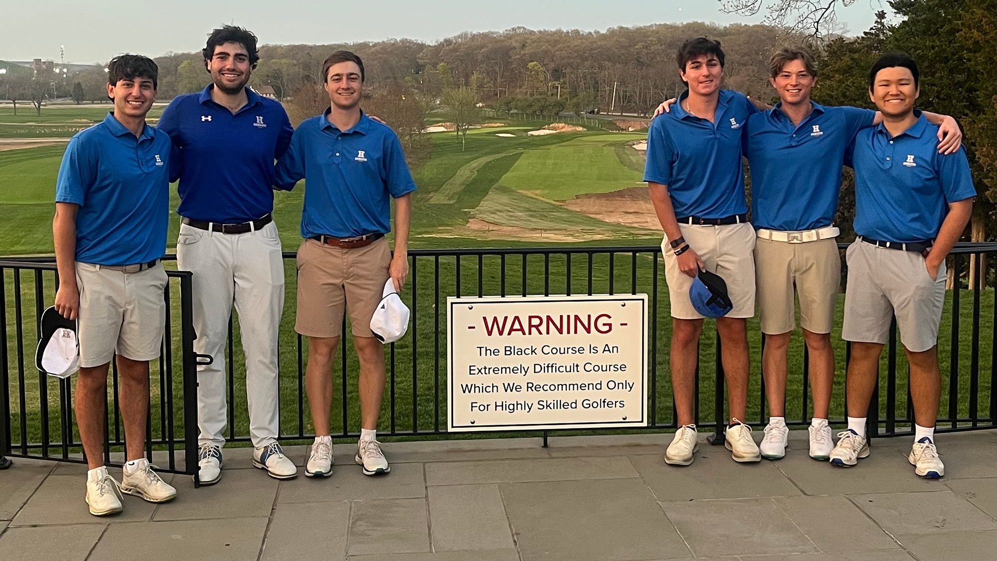 Six members of the Men's Golf team pose near the first tee at Bethpage Black Course in April 2026