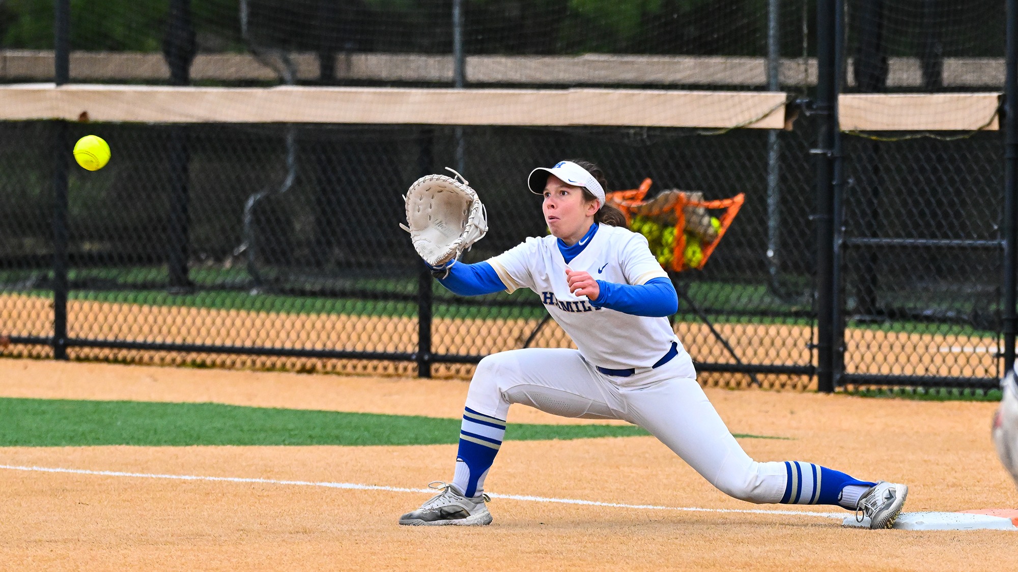 Hadley Rogers stretches out to catch a throw at first base in a softball game against Ithaca