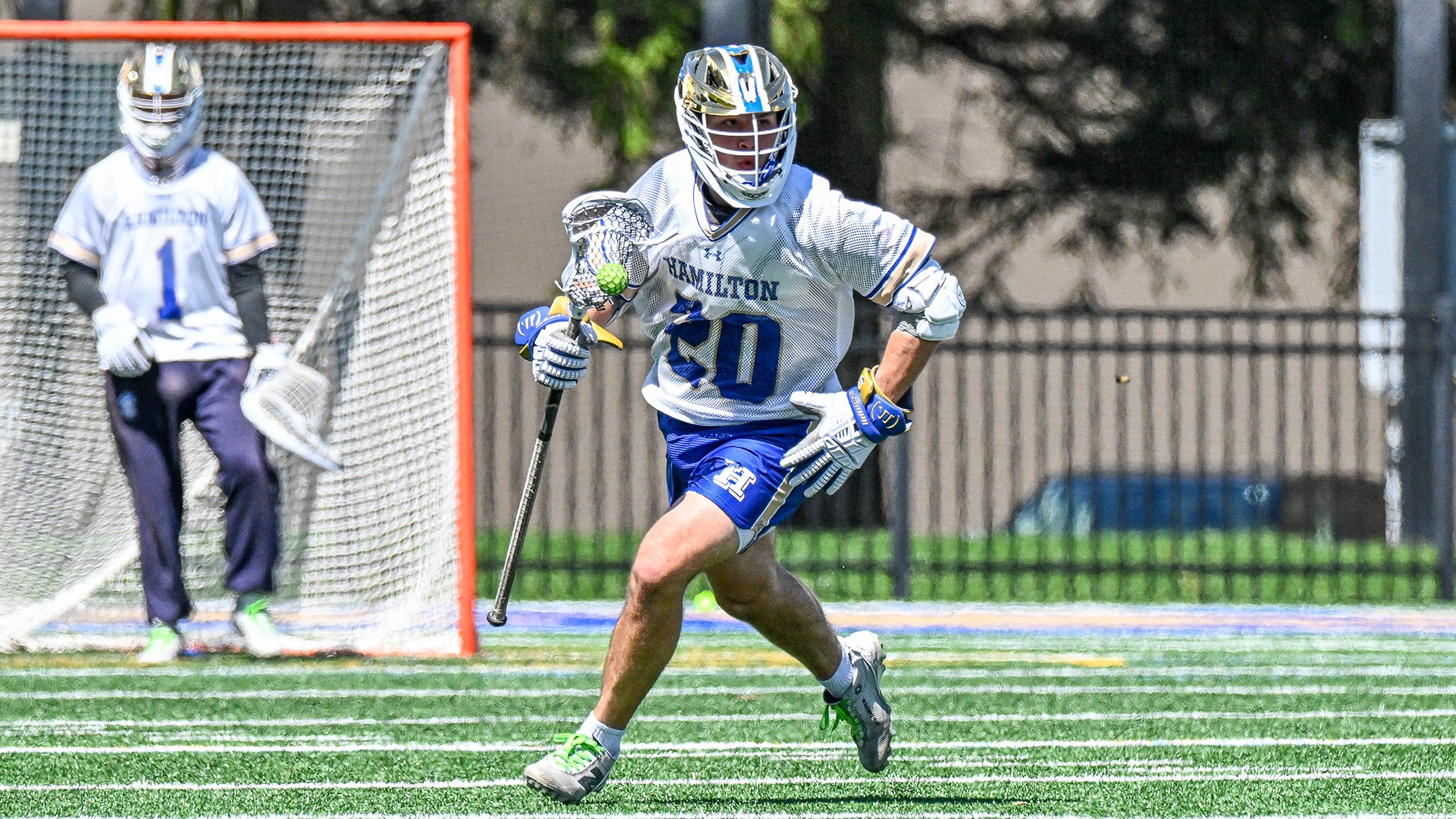 Ford Collins runs with the ball in a 2026 men's lacrosse game against Tufts