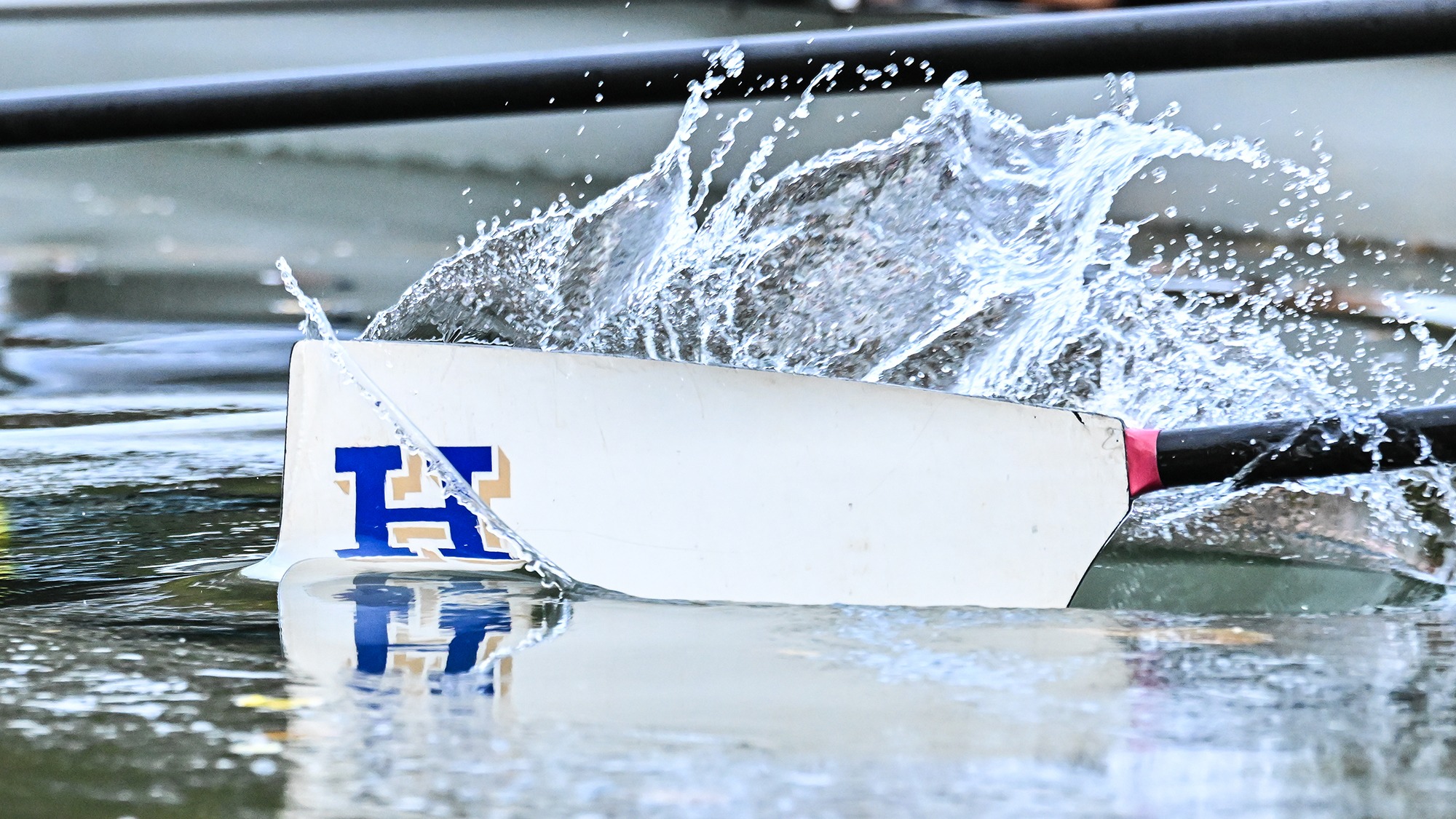 An Oar splashes in the Erie Canal during rowing practice in October 2025