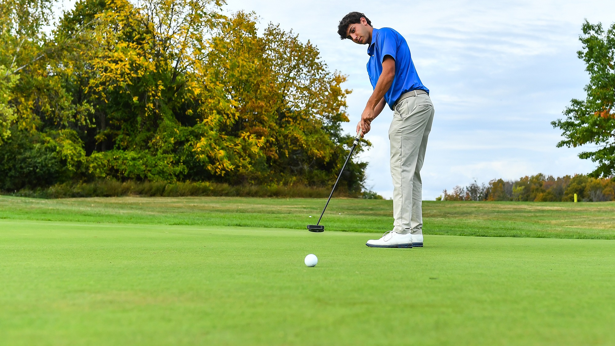Jake Hendelman sends a putt on its way to the hole on Hamilton's practice green in September 2025