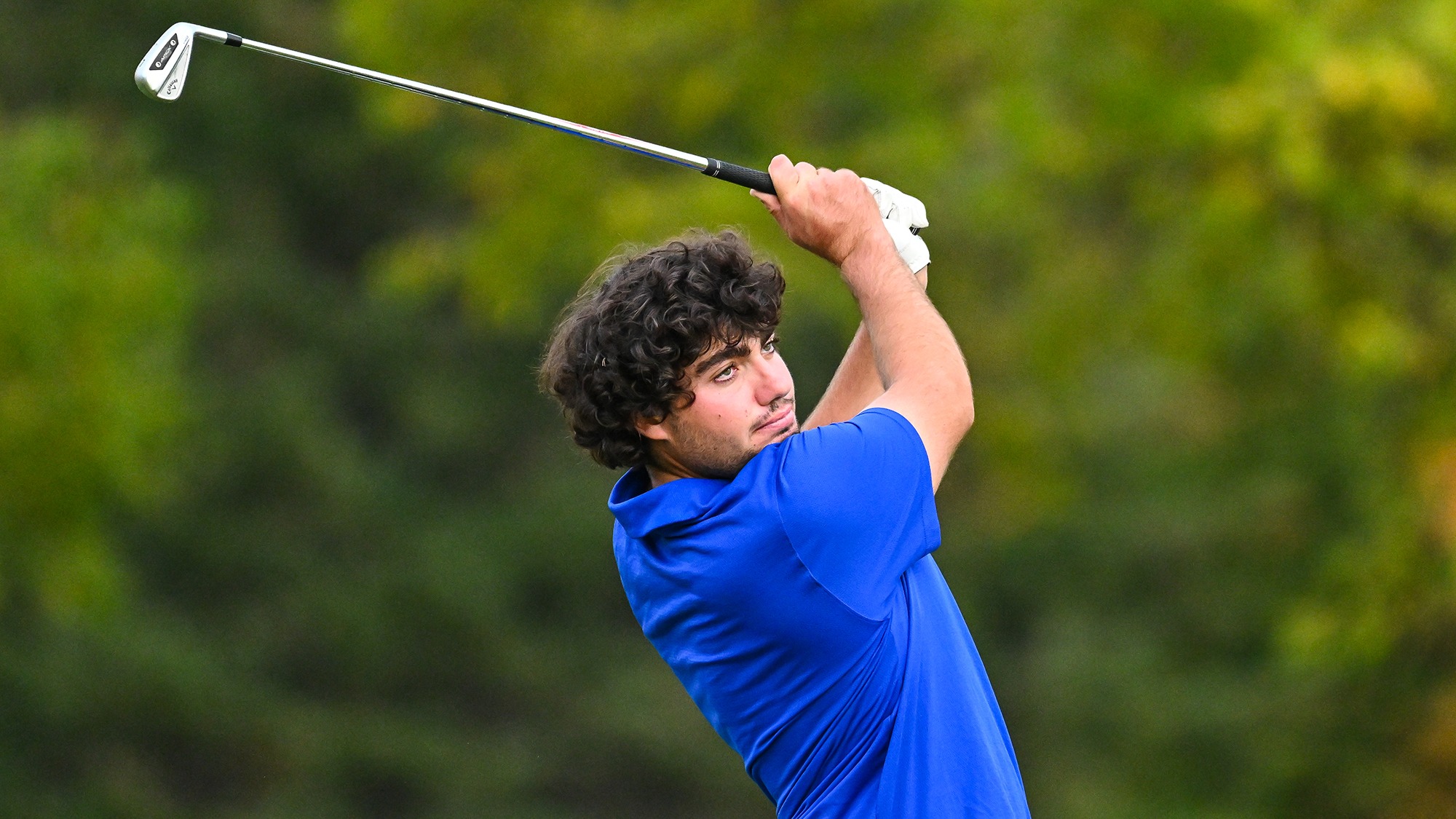 Ramon Aroca Gonzalez watches his iron shot on the driving range during golf practice in September 2025