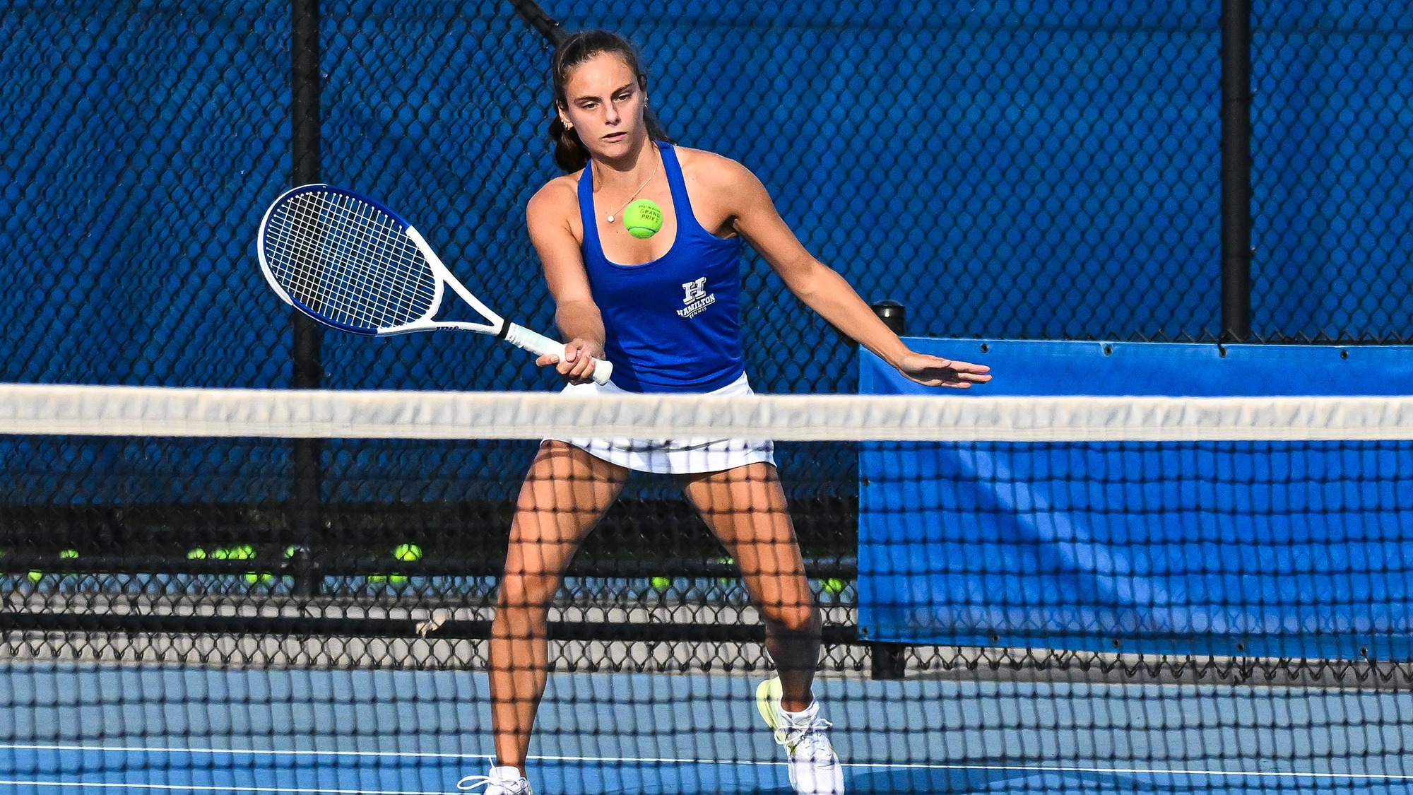 Samantha Rainero volleys at the net during women's tennis practice in September 2025