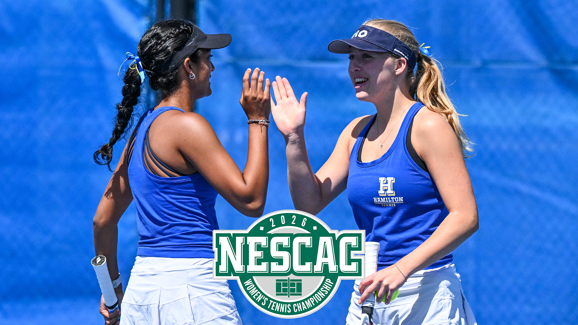 Women's Tennis teammates Priyanka Challapalli and Hannah Walpole high-five each other during the 2026 Wesleyan match