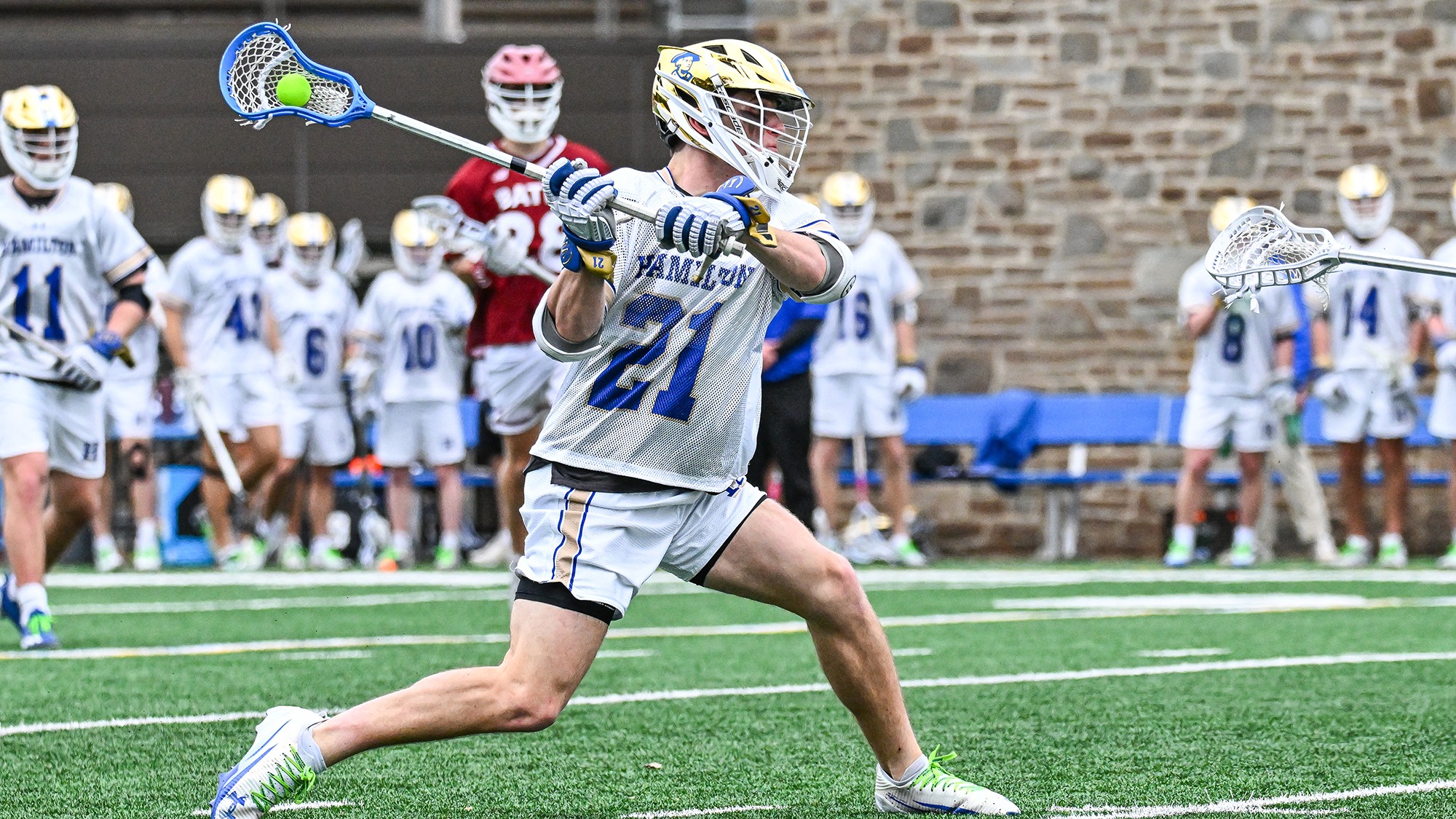 Carson Kraus winds up for a shot in a men's lacrosse game against Bates