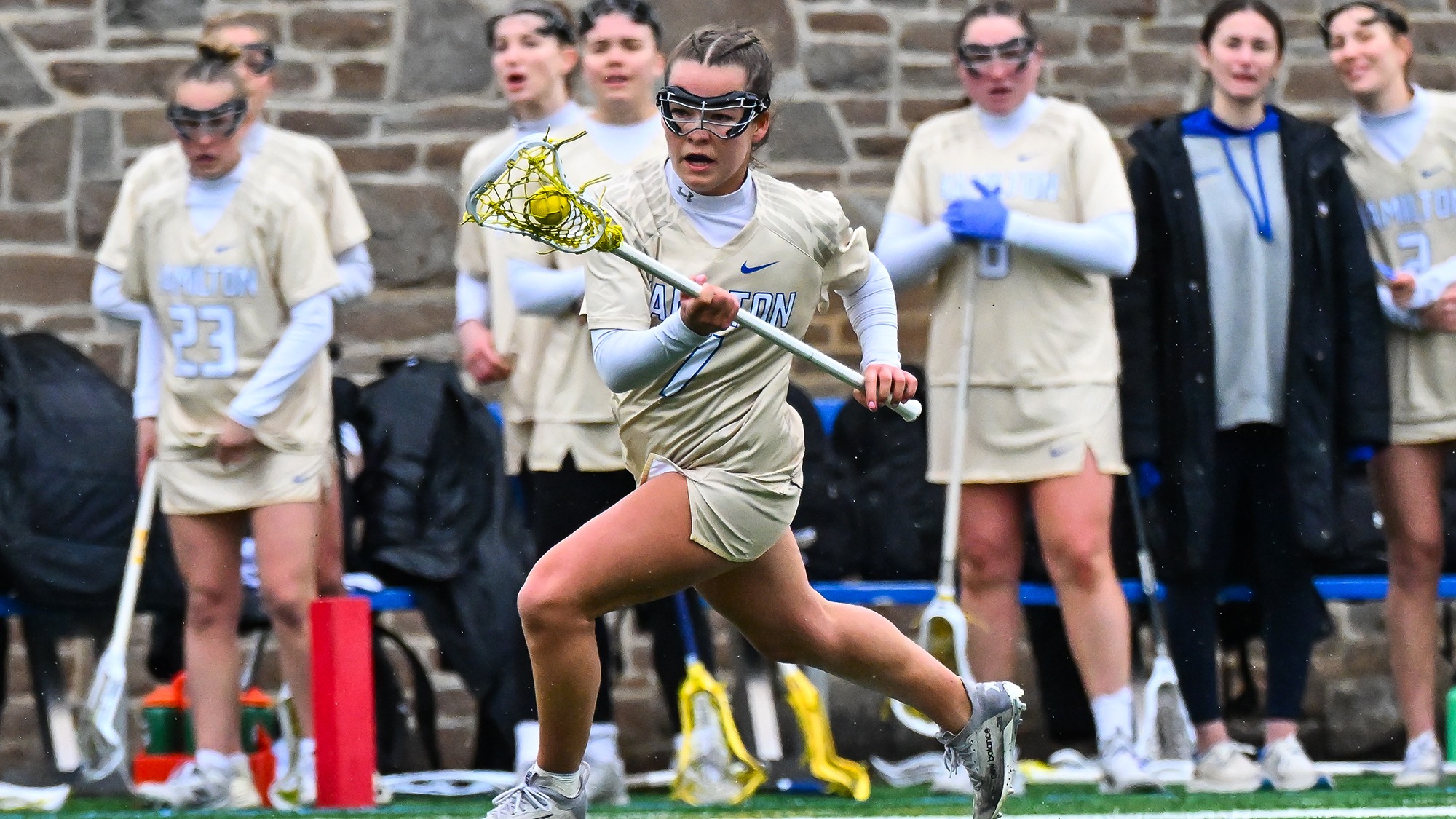 Maddigan Leifer brings the ball upfield during a clear attempt in a women's lacrosse game against Wesleyan