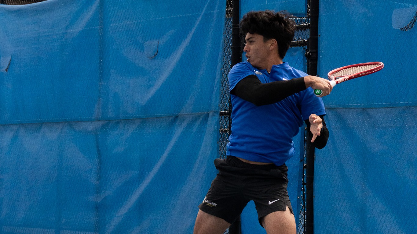 Lleyton Mendieta hits a forehand return during a men's tennis match against Amherst