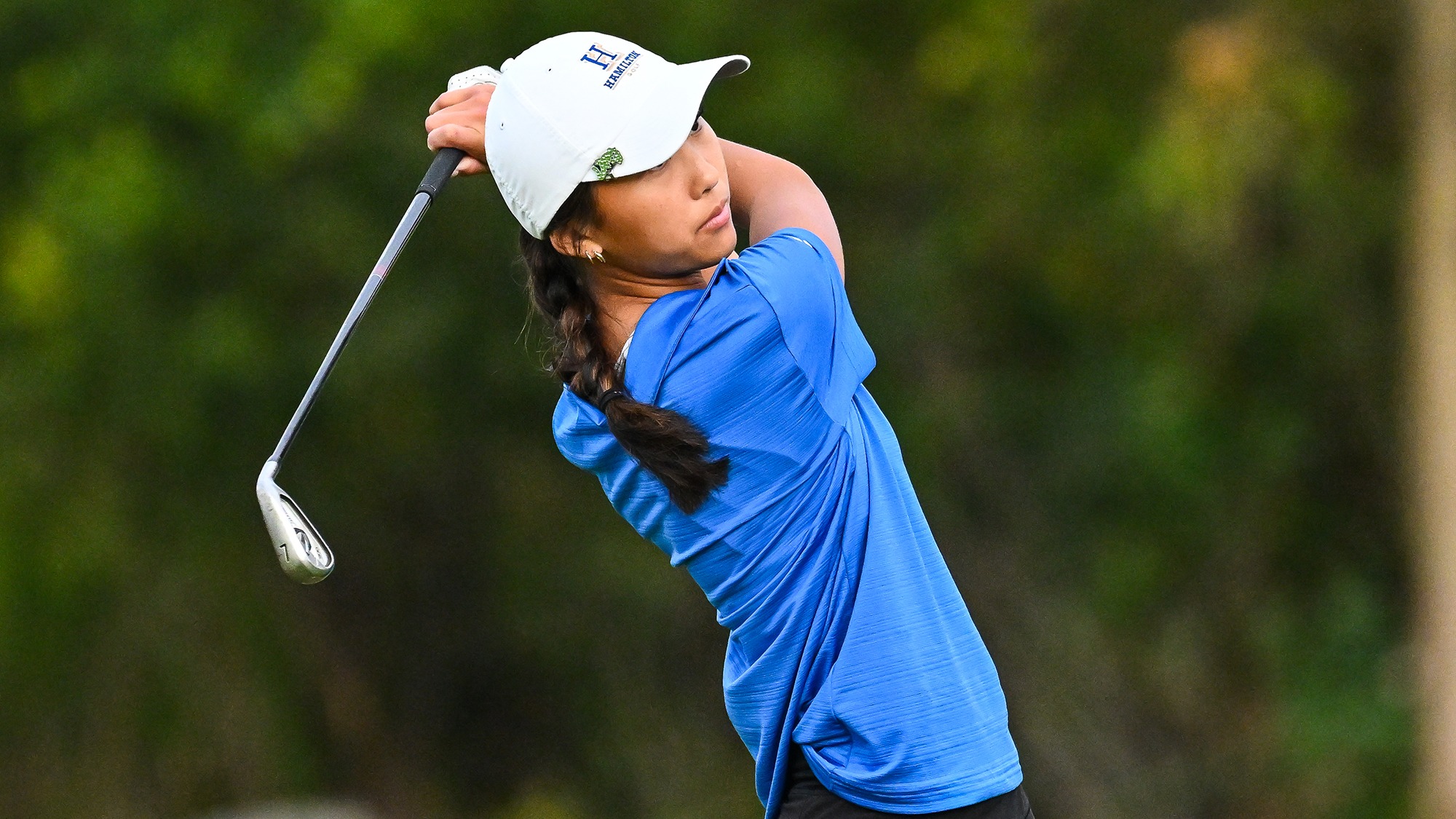 Aubrey Lee hits 7 iron on the driving range at women's golf practice in September 2025