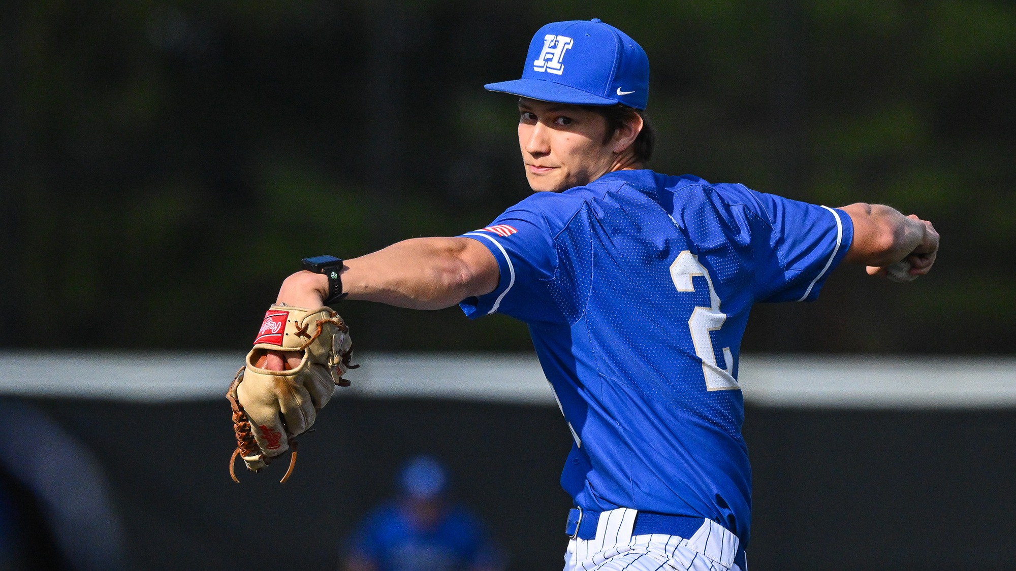 Mantas Kempinas goes into the windup before throwing a pitch in a baseball game against Wesleyan