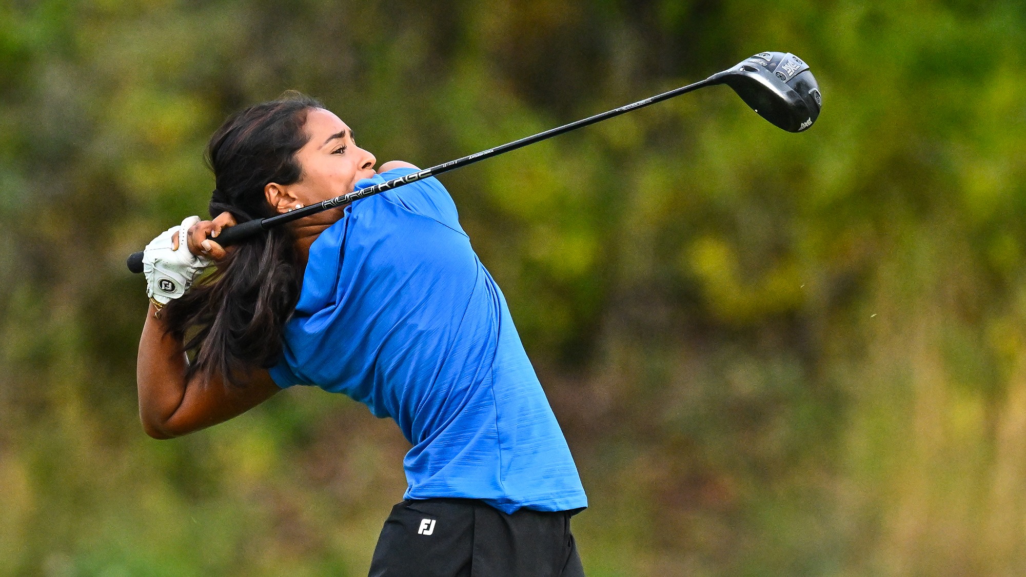 Shanya Arasu hits driver on the driving range during women's golf practice in September 2025