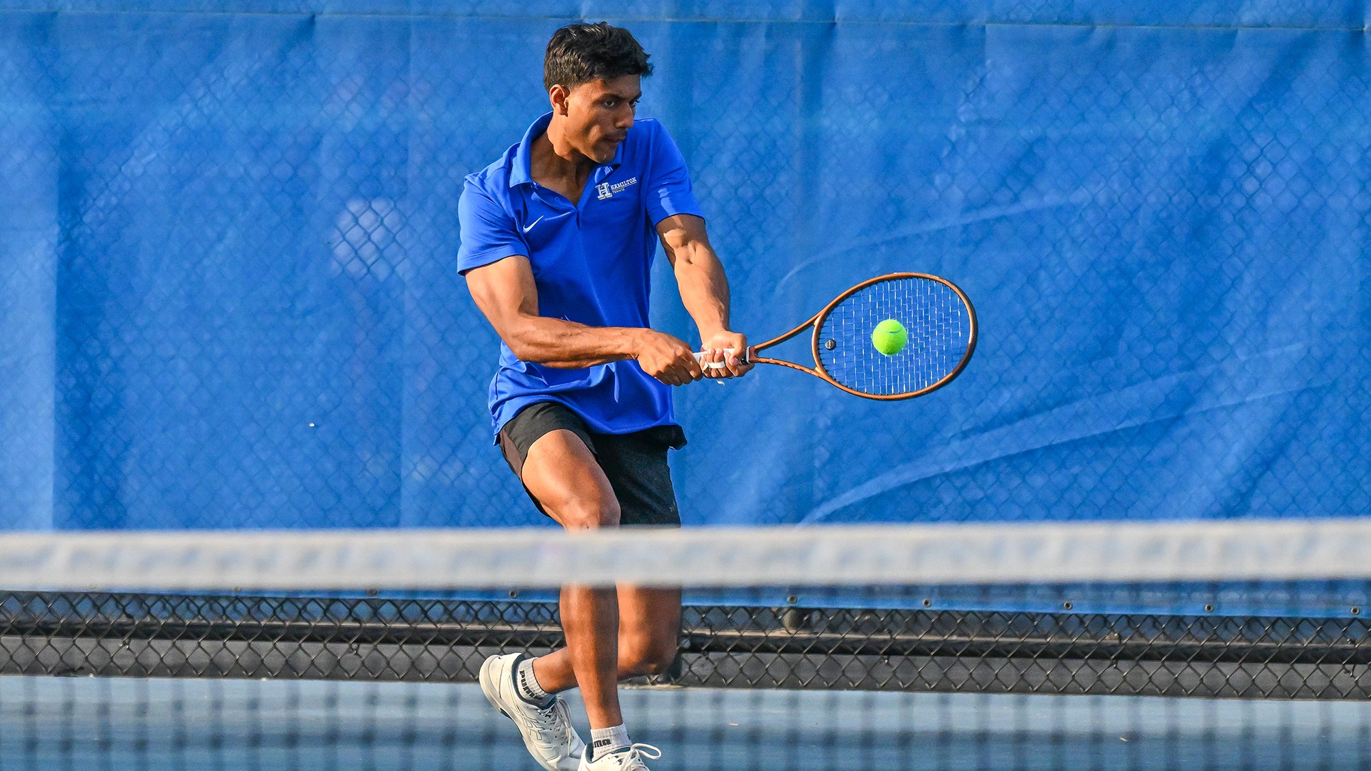 Tarun Korwar prepares to hit a backhand return during men's tennis practice in September 2025
