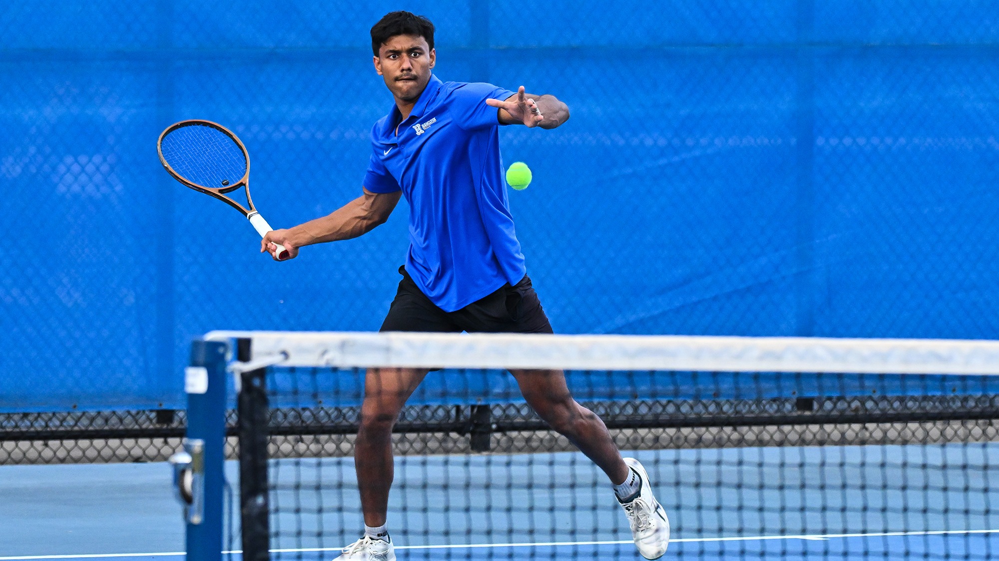 Tarun Korwar prepares to hit a forehand return during men's tennis practice in September 2025