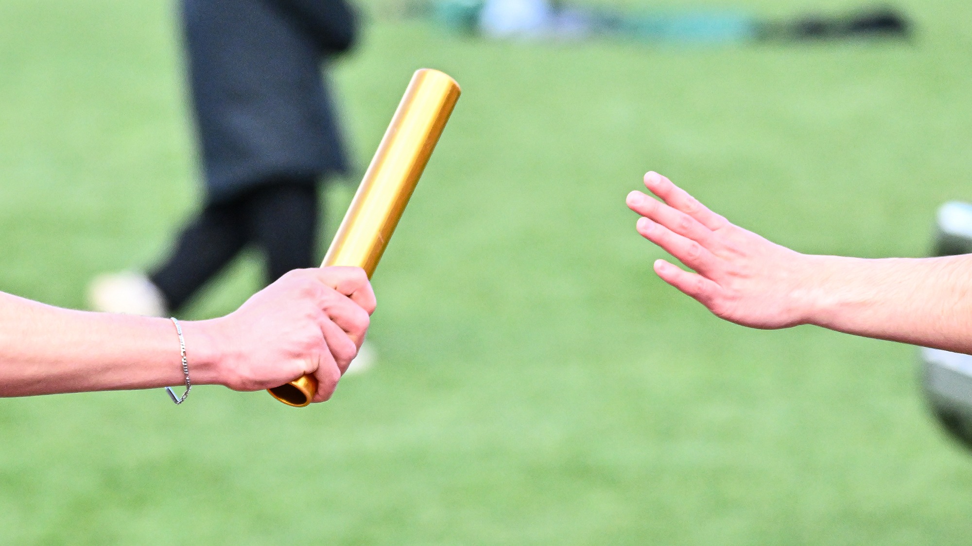 Track and Field athletes hand the baton off to each other during a relay in the 2026 Hamilton Outdoor Invitational