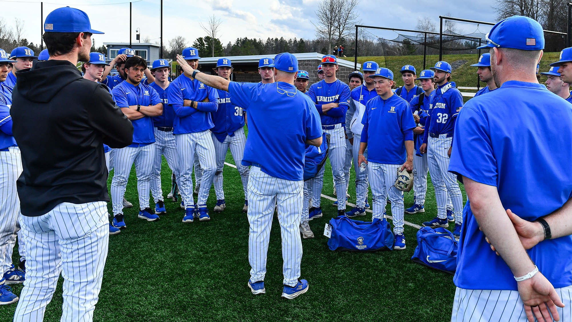 The Baseball team listens to head coach Tim Byrnes after their win against Wesleyan