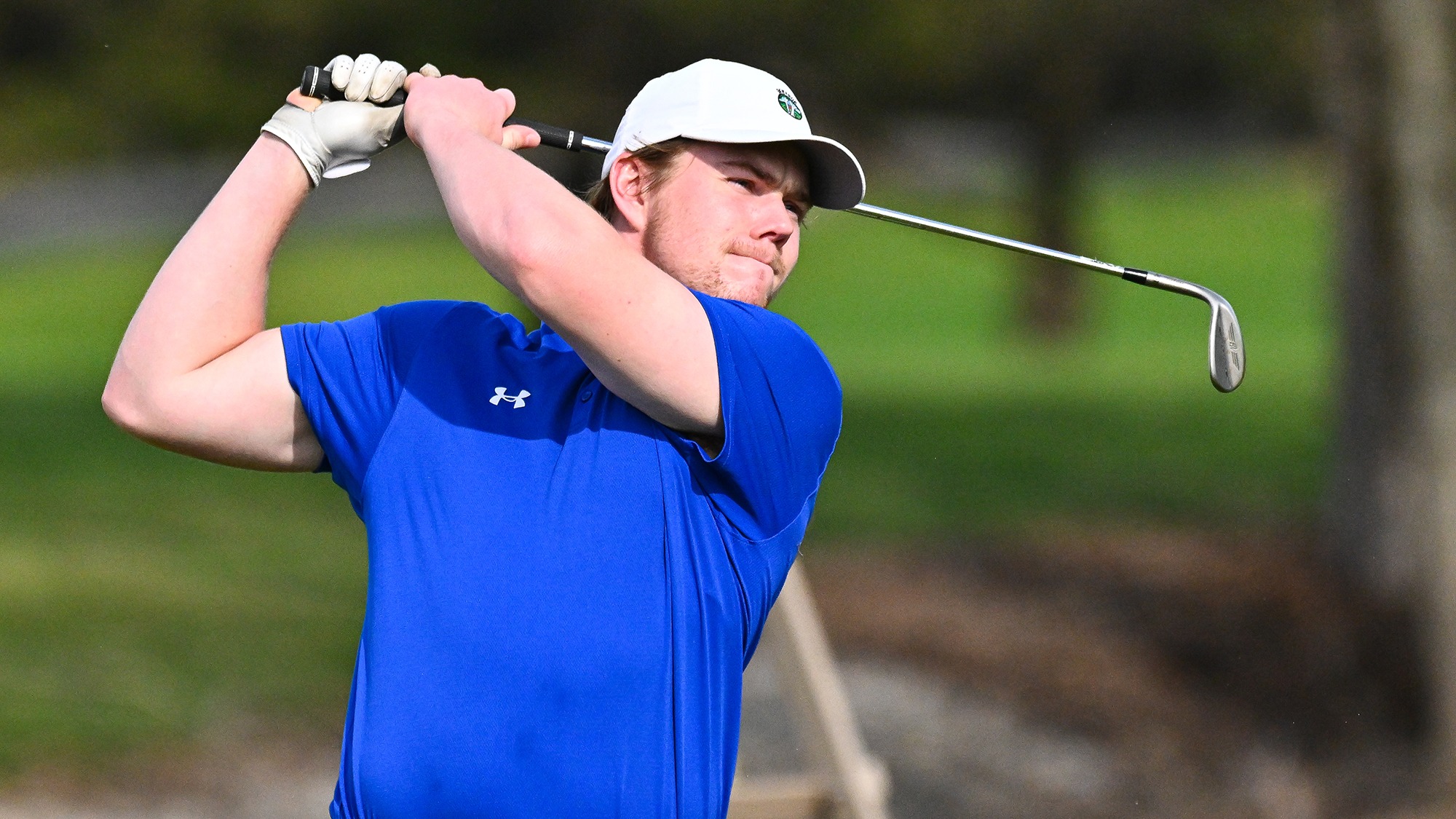 Thomas Beaudoin watches his golf shot on the driving range during practice in April 2026