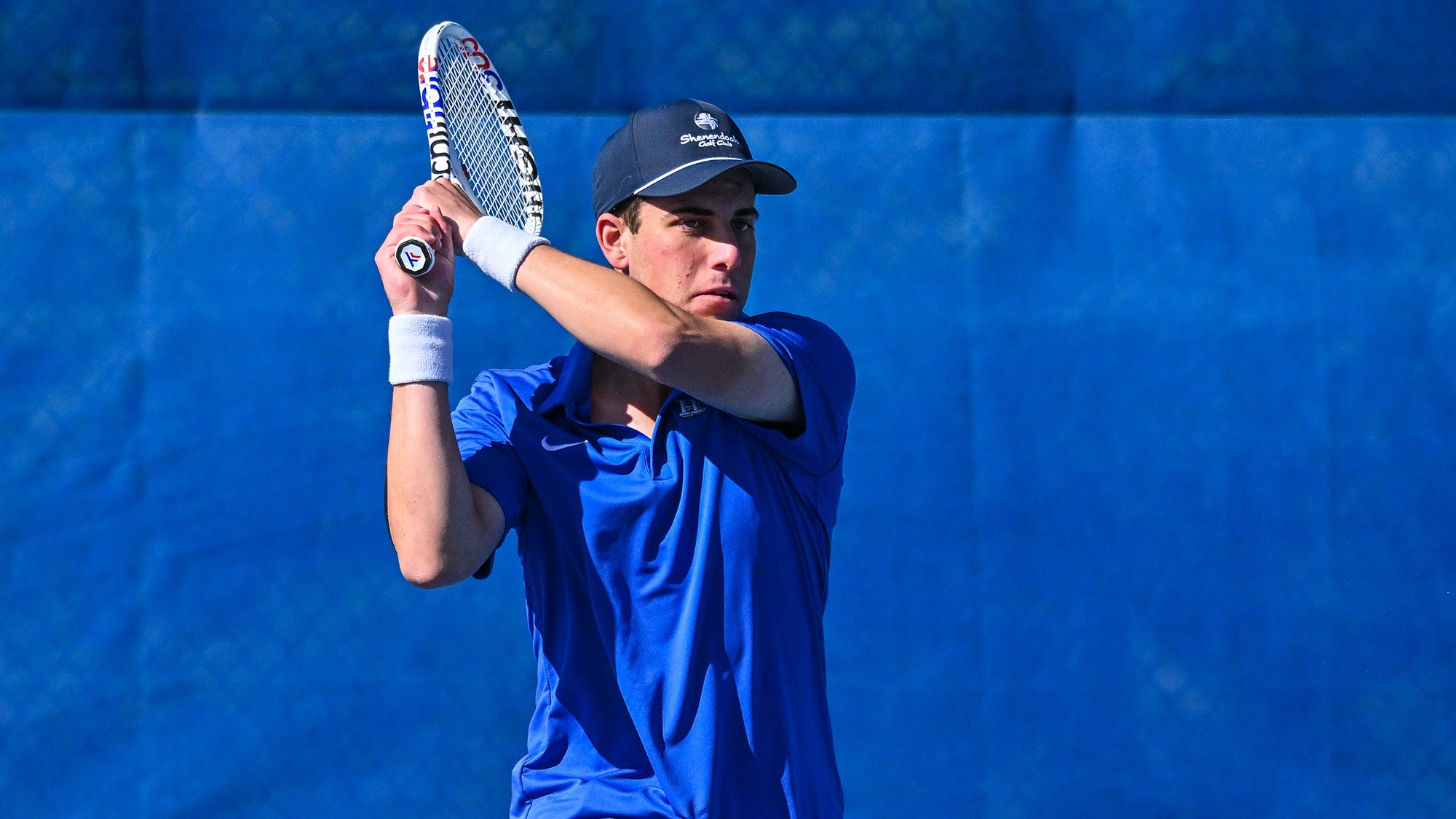 Charlie Sternberg hits a return during men's tennis practice in April 2025