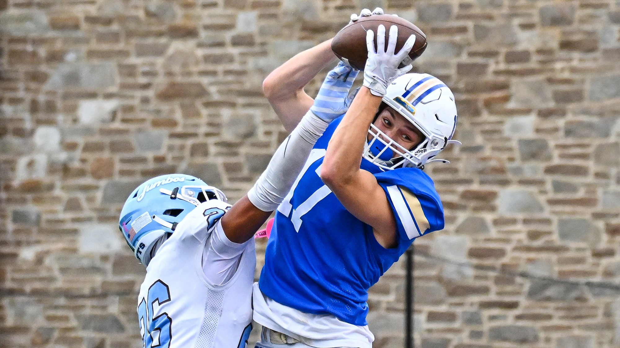 Mitchell Ivatts catches a pass over a Tufts football defensive back