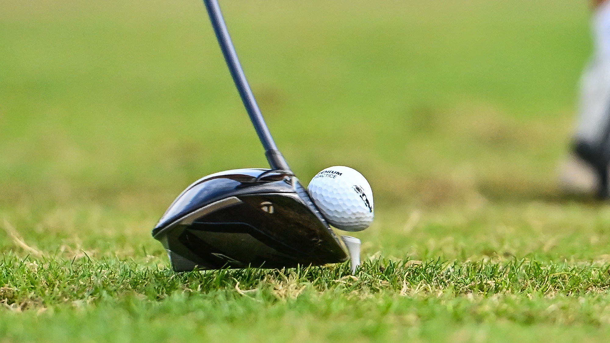 Golf club head hits the ball off the tee during practice in September 2025
