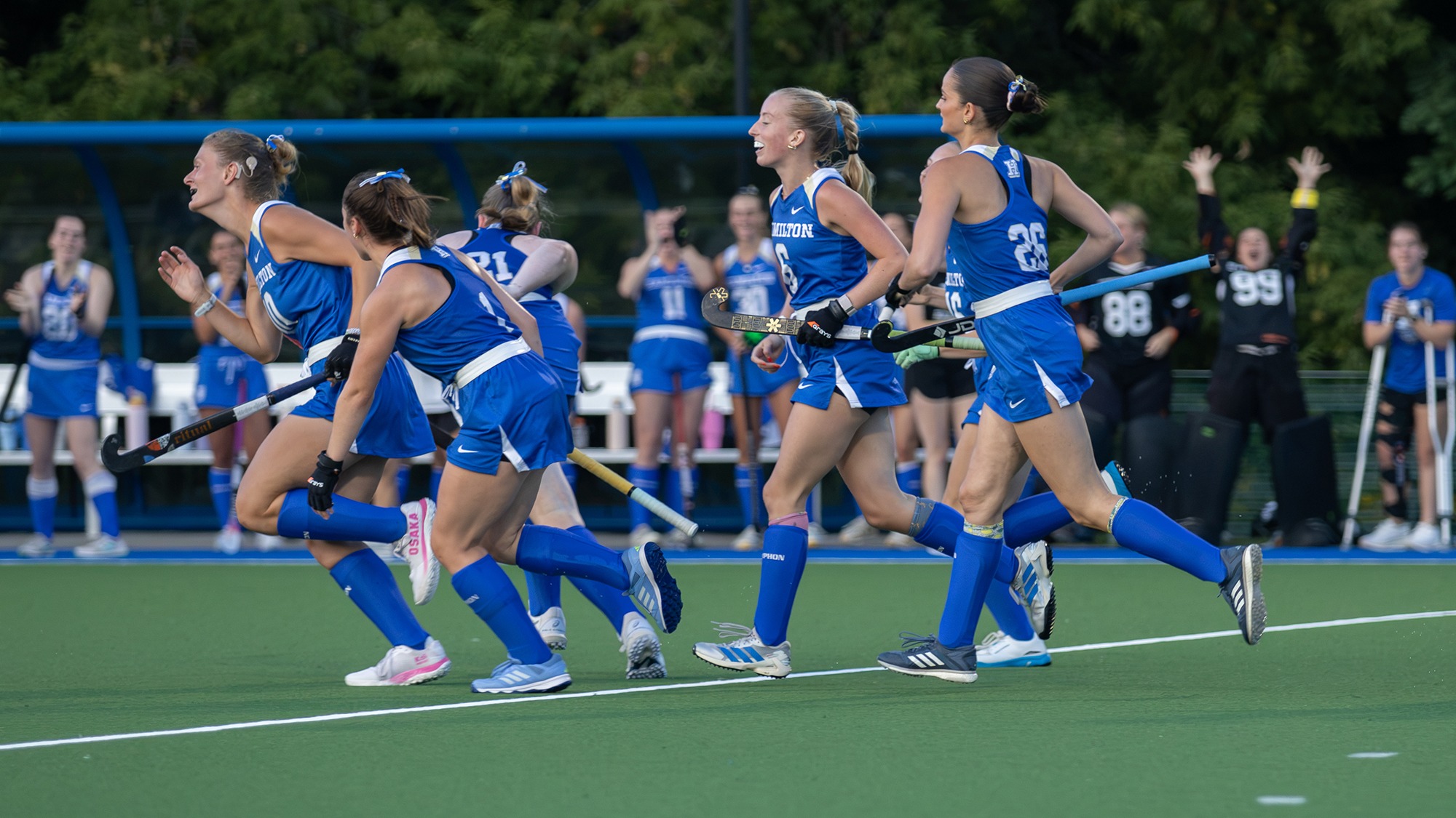 Field Hockey players run back to midfield after scoring a goal against RPI